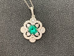0.81 Carat Round Cut Emerald and Diamond Pendant Necklace in 18K