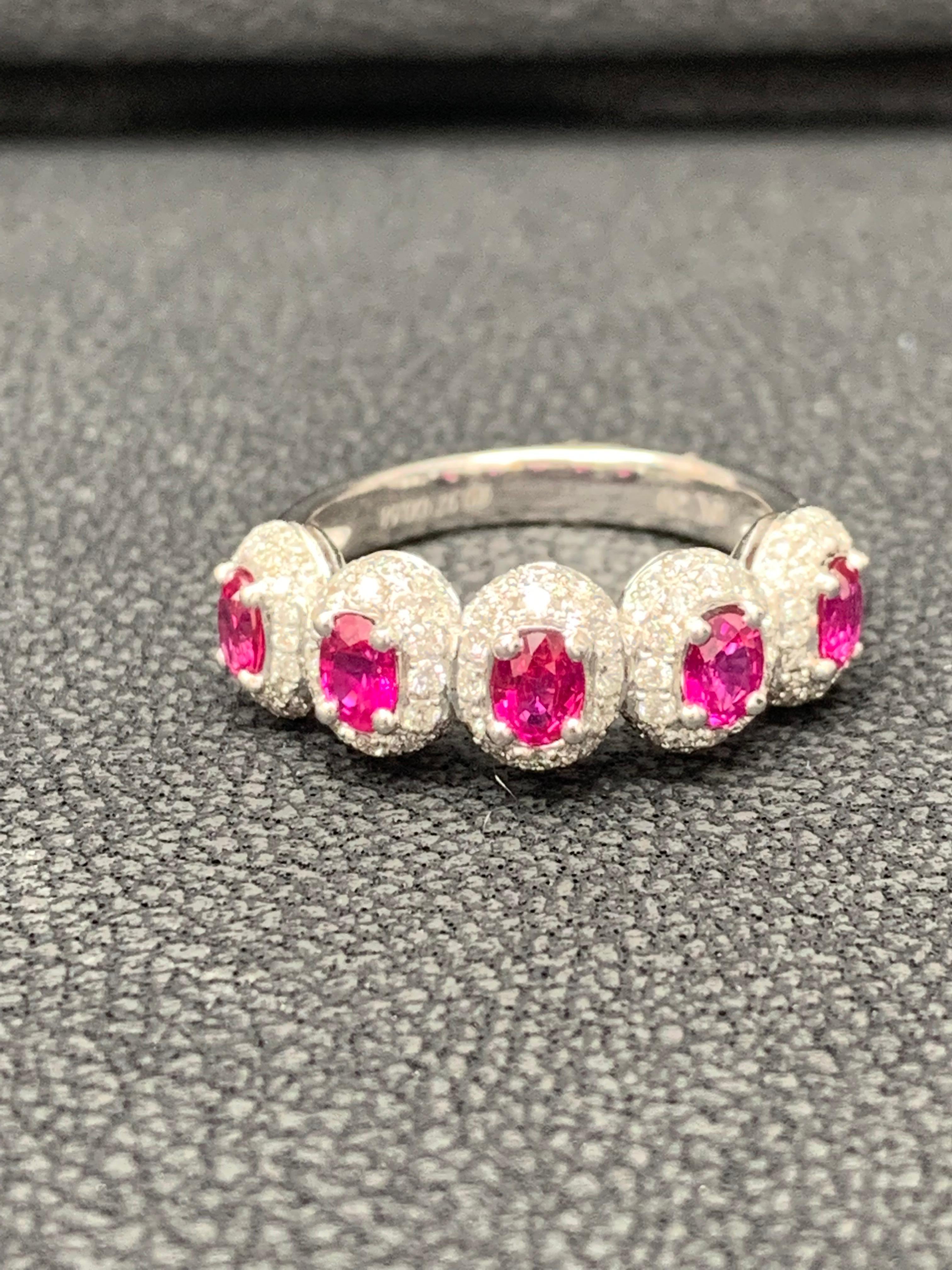 Beautiful ring set with 5 oval cut rubies weighing 1.15 carats total. Each ruby is surrounded by a single row of round cut melee diamonds weighing 0.66 carats total. Set in 18k white gold. 

Size 6.5 US (Sizable). One of a Kind  piece.
All diamonds