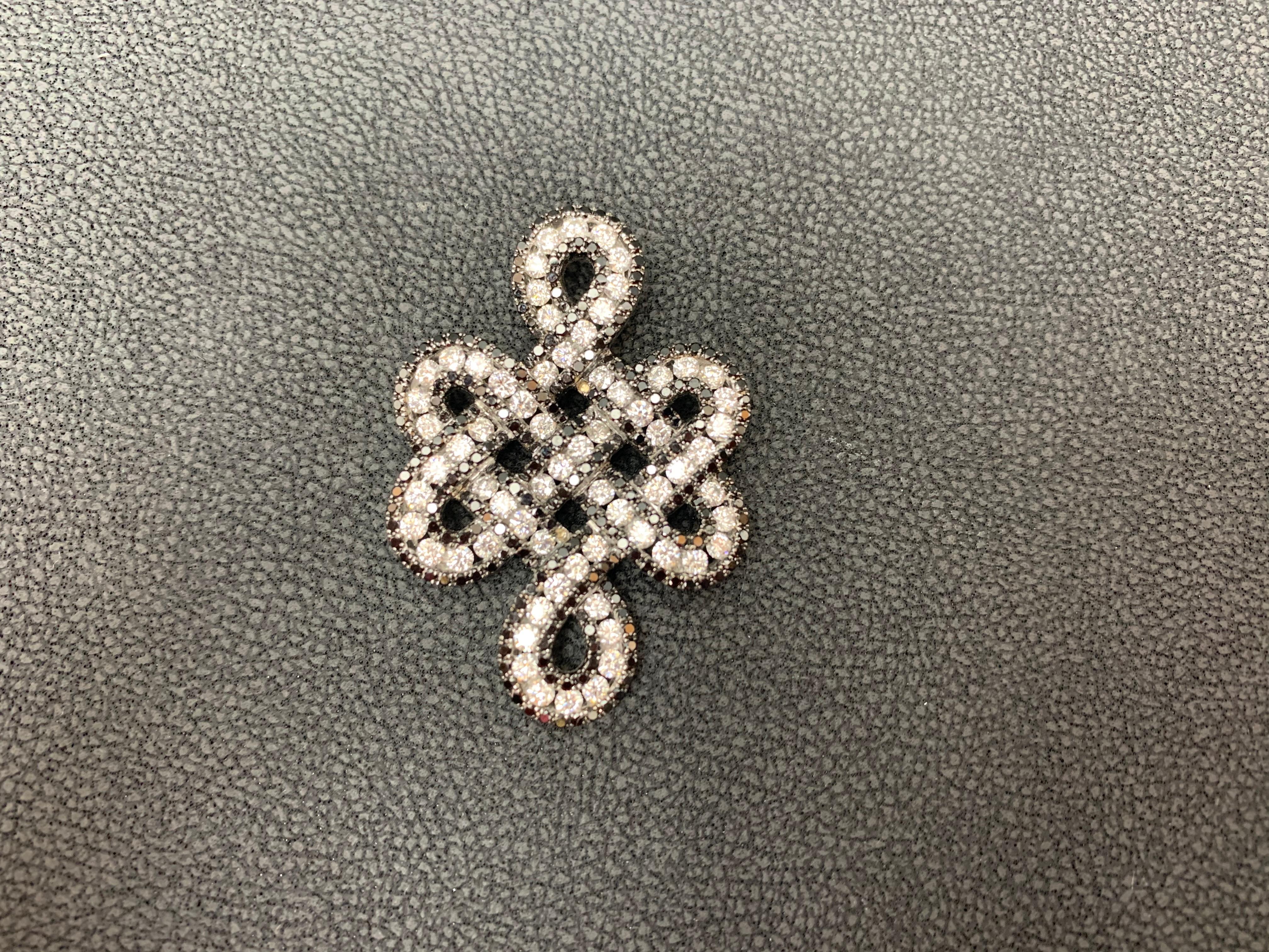 Showcasing a 18 karat white gold open work design Pendant, encrusted with white and black diamonds all over White diamonds weigh 2.04 Carats total, black diamonds weigh 1.31 carats total. 18
