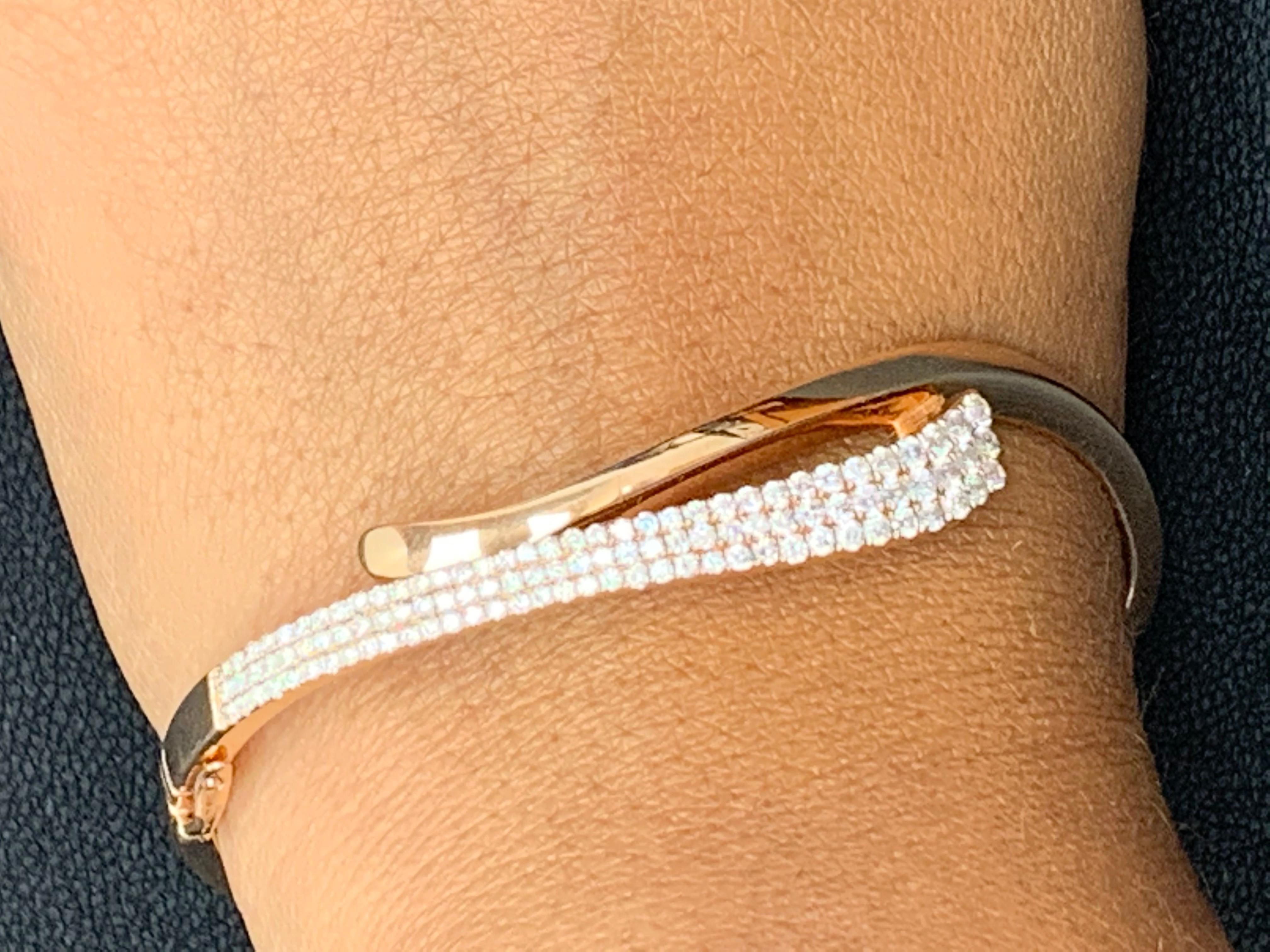 A simple yet elegant piece of jewelry set with 108 round brilliant diamonds in pave set weighing 1.36 carats total. Has a clasp for ease of wear and to secure the bangle in place. Made in 14k rose gold.

All diamonds are GH color SI1