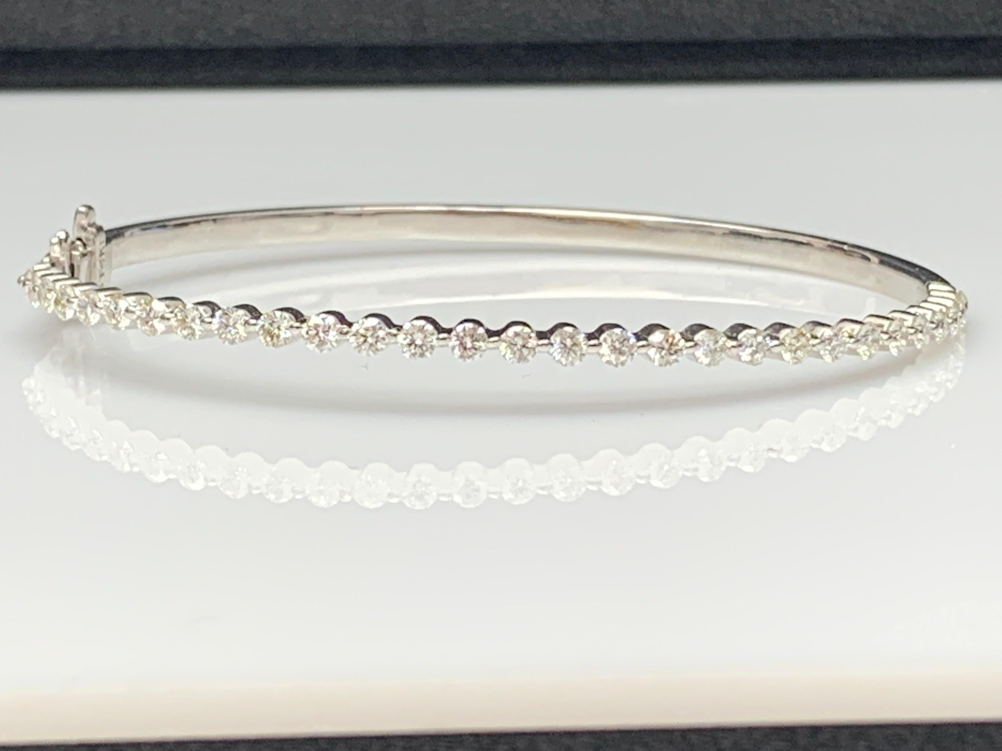 A stunning bangle bracelet set with 29 brilliant cut diamonds weighing 1.75 carat total. Set in polished 14k white gold. Double lock mechanism for maximum security. A simple yet dazzling piece.

All diamonds are GH color SI1 Clarity.
Style available