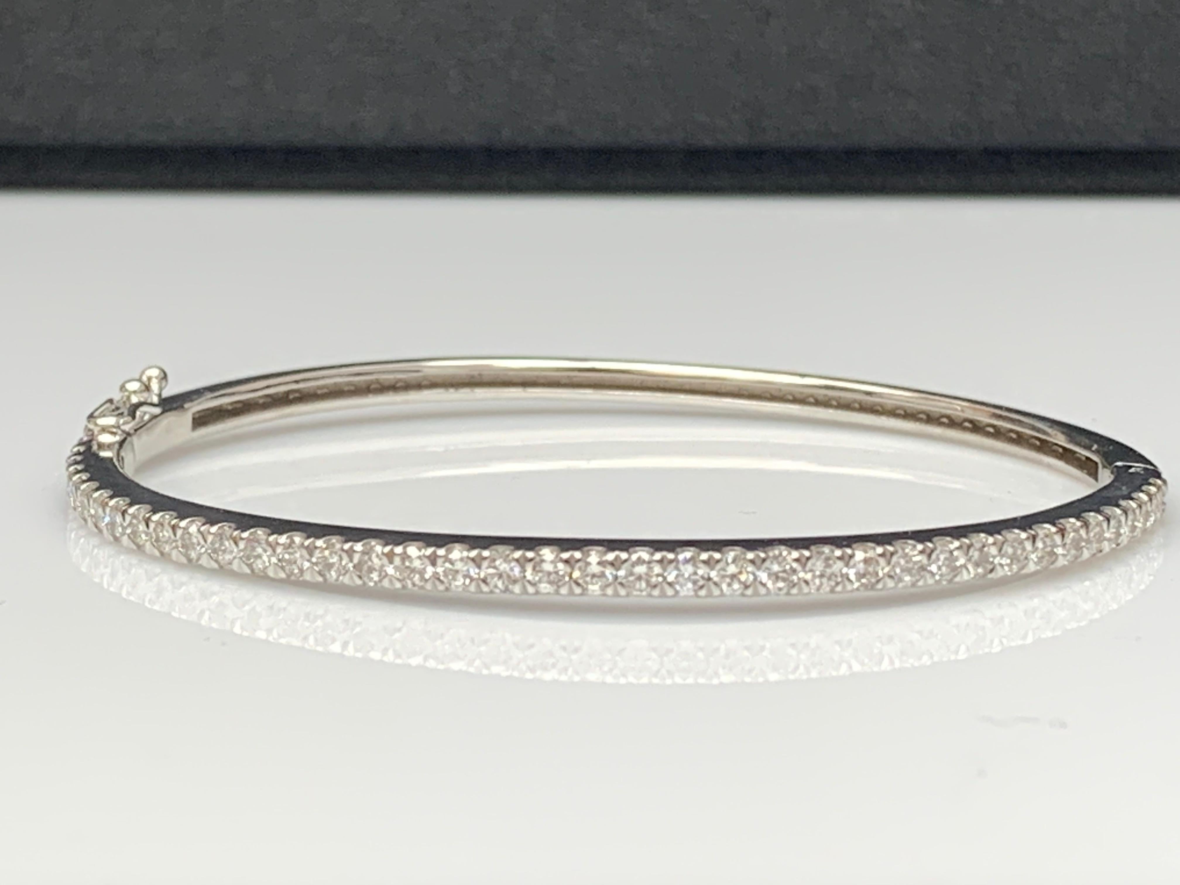 A stunning bangle bracelet set with 39 brilliant cut diamonds weighing 1.78 carat total. Set in polished 14k white gold. Double lock mechanism for maximum security. A simple yet dazzling piece.

All diamonds are GH color SI1 Clarity.
Style available