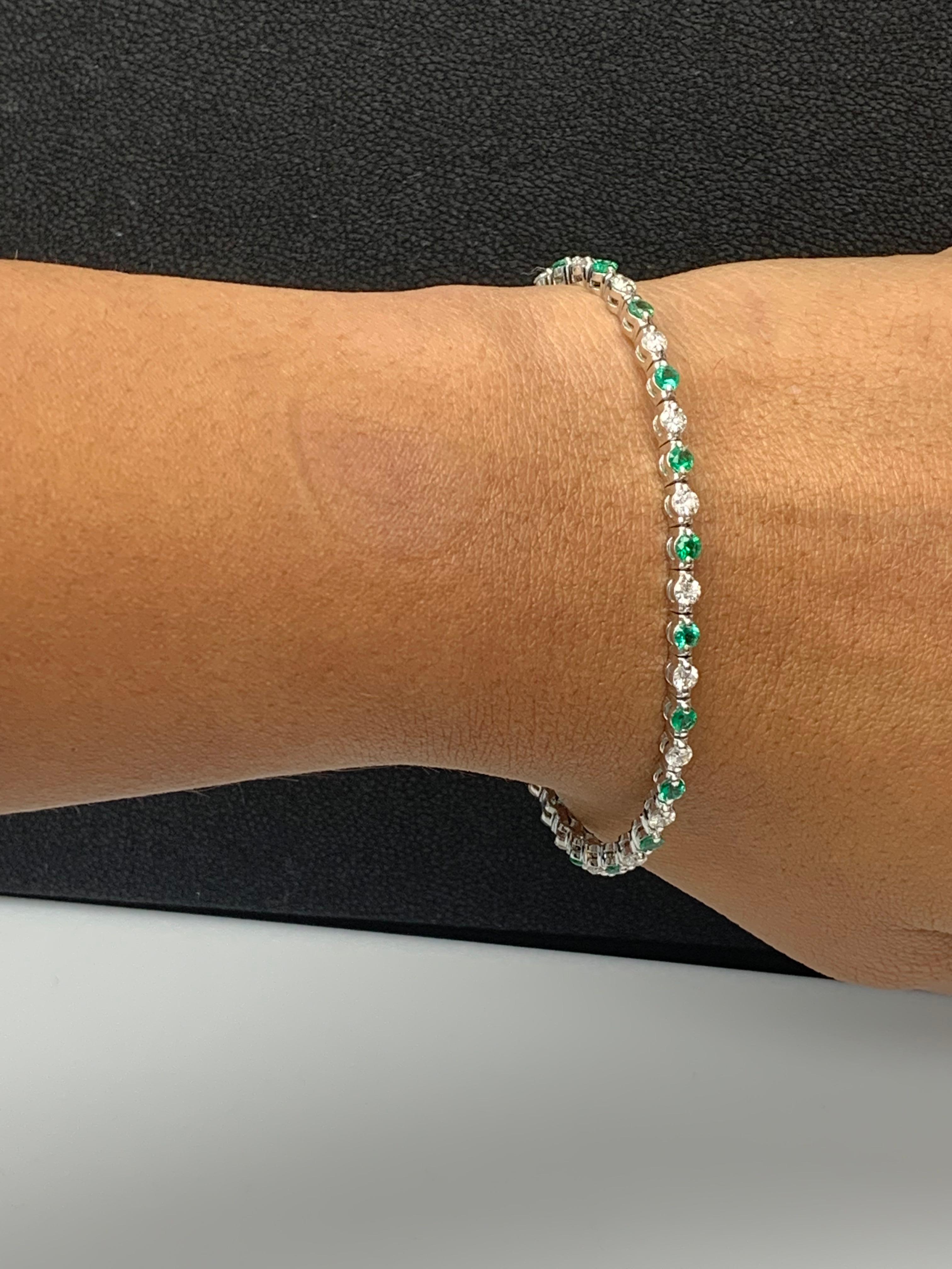 A stunning bracelet set with 21 Lush Green Emeralds weighing 2.24 carat total. Alternating these emeralds are 20 sparkling round diamonds weighing 1.60 carats total. Set in polished 14k white gold. Double lock mechanism for maximum security. A