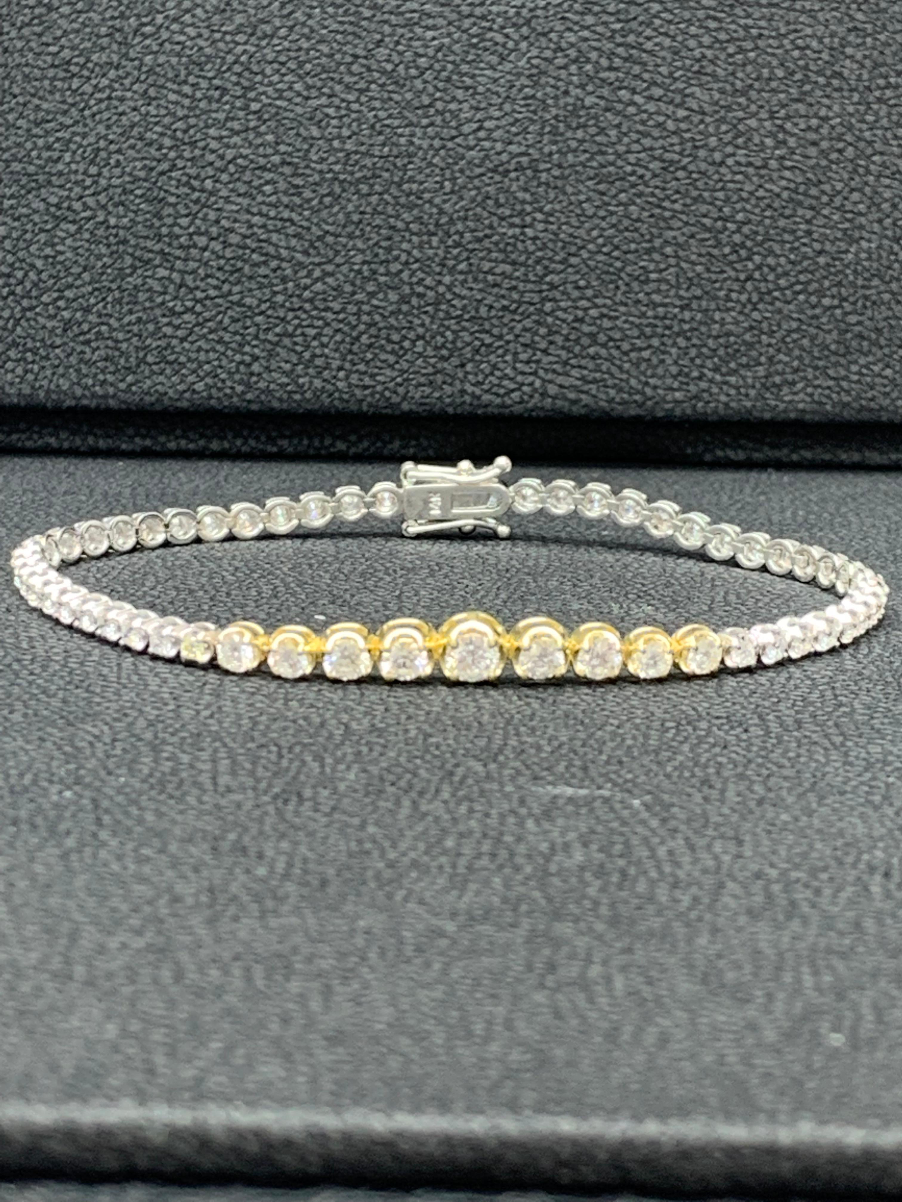 An absolutely stunning tennis bracelet that will catch everyone's attention. Features an outstanding 2.25 carats of 55 brilliant round cut diamonds. The diamonds shine brilliantly in their 14k white and yellow gold mounting.

All diamonds are GH