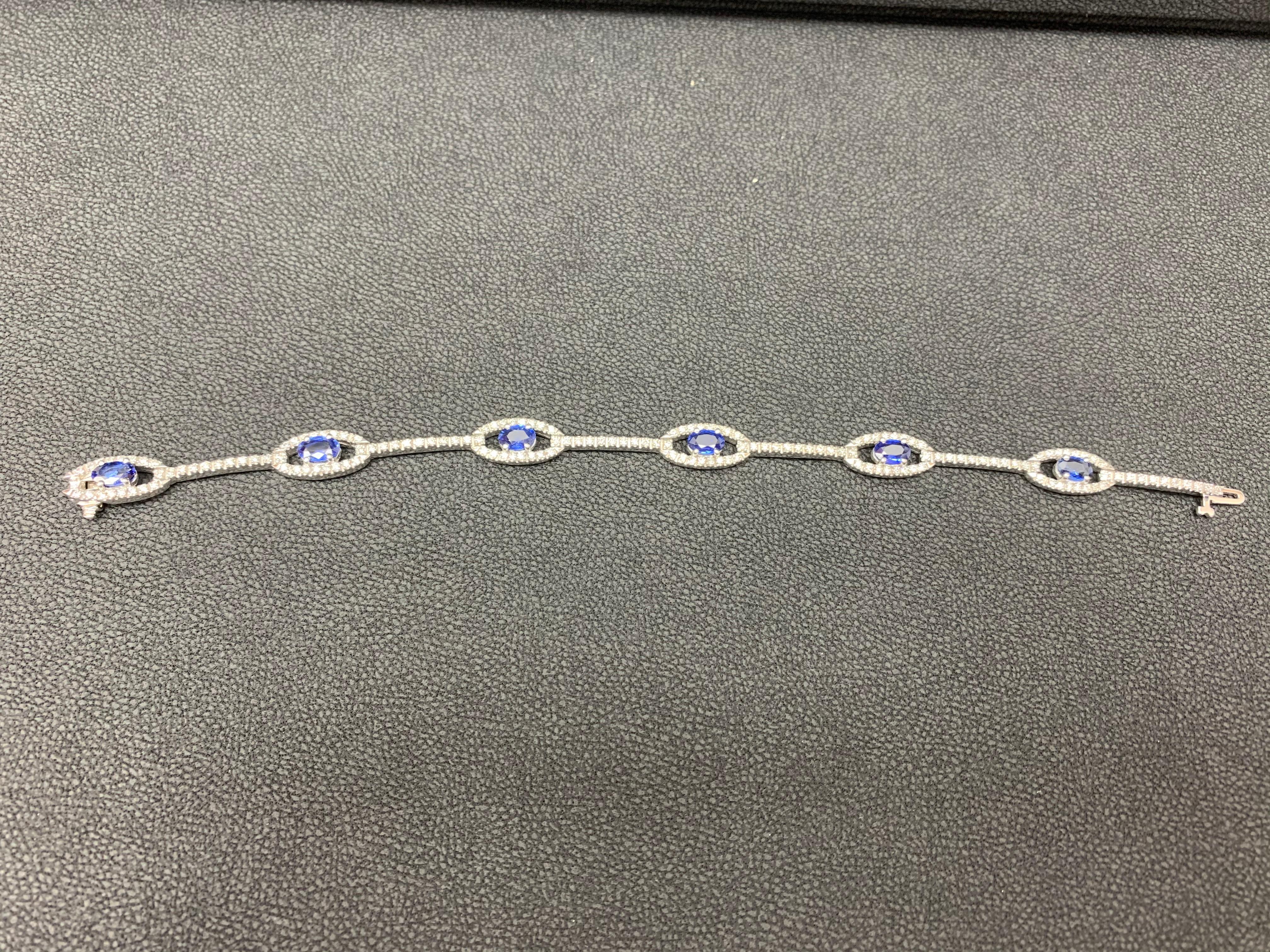 Gorgeous tennis bracelet set with 6 Blue Sapphires weighing 2.46 Carats in total.  Each link is attached to a white gold bar set with round diamonds. Sapphires is accented by a single row of round brilliant diamonds. Toal weight of Diamonds 1.14
