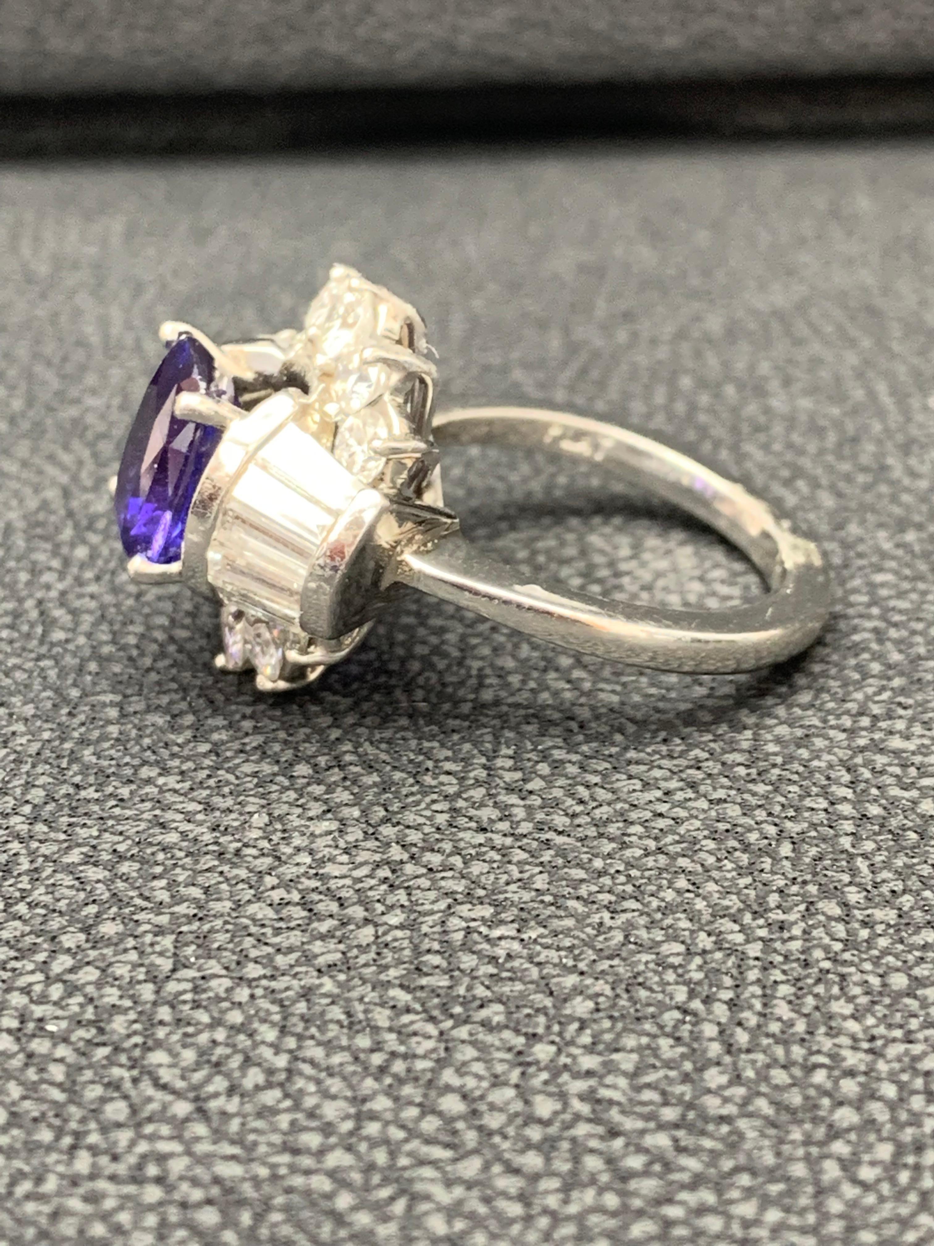 Showcasing a 4.20 carat cushion cut blue sapphire. BLUE color with no indications of heat treatment. Surrounding the sapphire is a row of round and baguette brilliant diamonds, in a diamond encrusted mounting made in platinum. Accent diamonds weigh