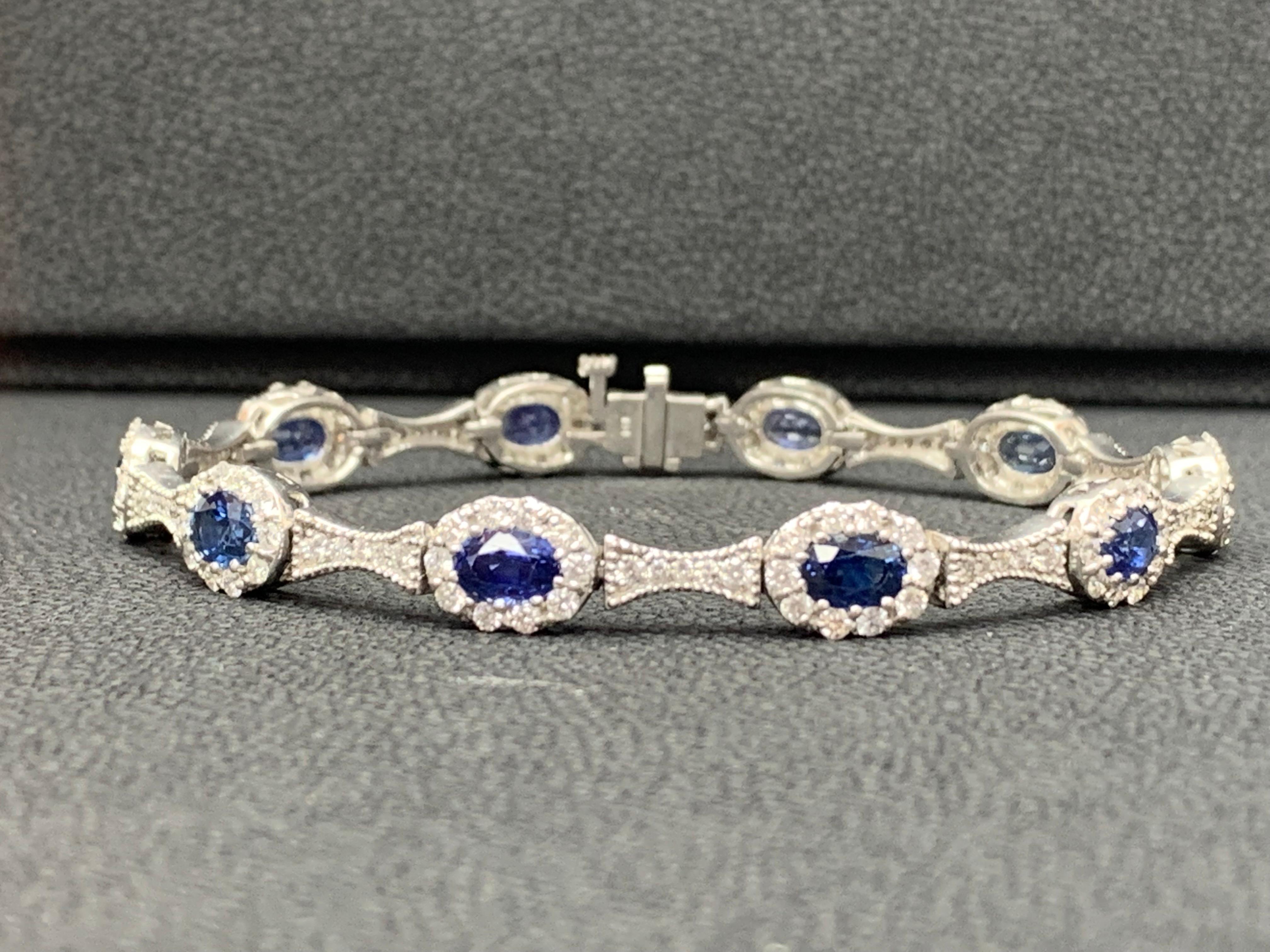 An exquisite and luxurious bracelet showcasing 6.19 carats of oval cut blue sapphires, surrounded by brilliant round diamonds weighing 2.80 carats total. Set in an 14 karat white gold mounting.

All diamonds are GH color SI1 Clarity.
Available in