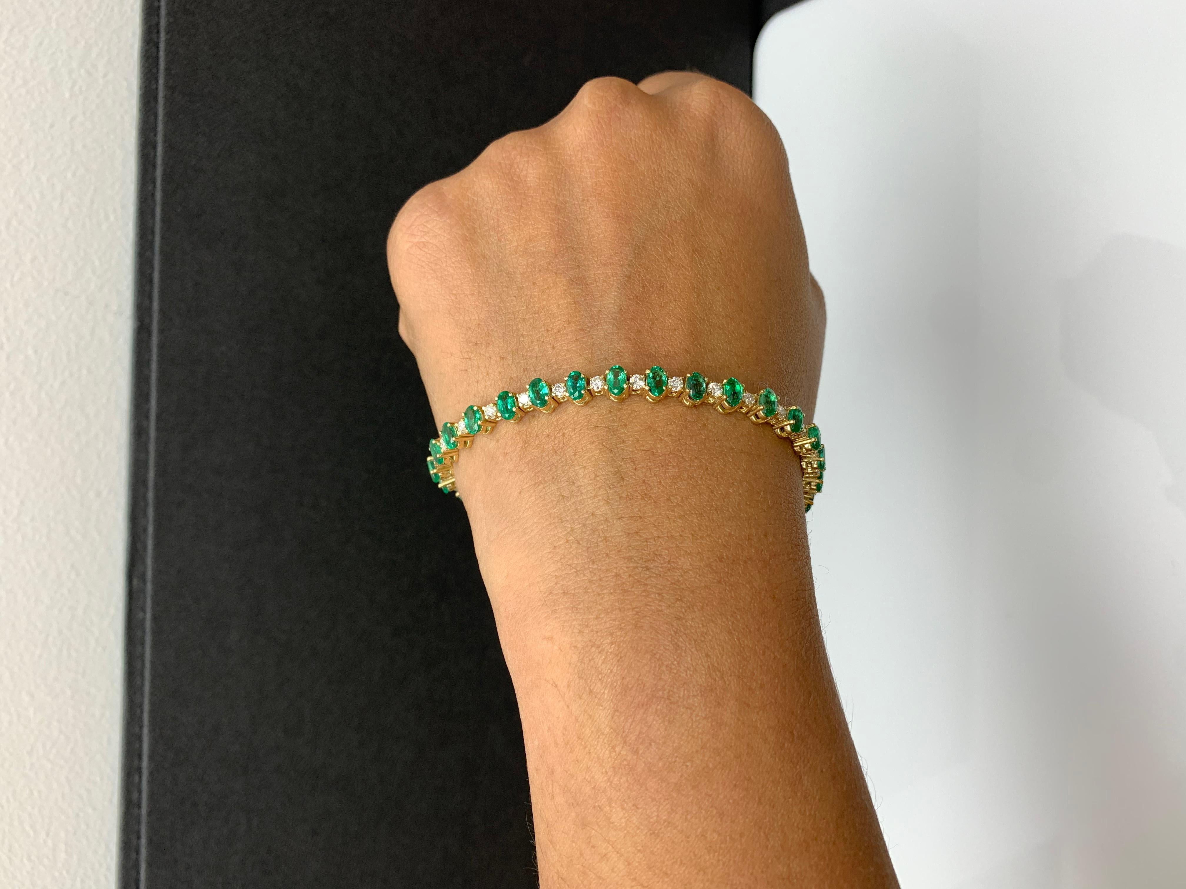 A stunning bracelet set with 30 Vibrant oval cut emeralds weighing 6.30 carats total. Alternating these emeralds are 30 sparkling round diamonds weighing 1.48 carats total. Set in polished 14k yellow gold. Double lock mechanism for maximum security.