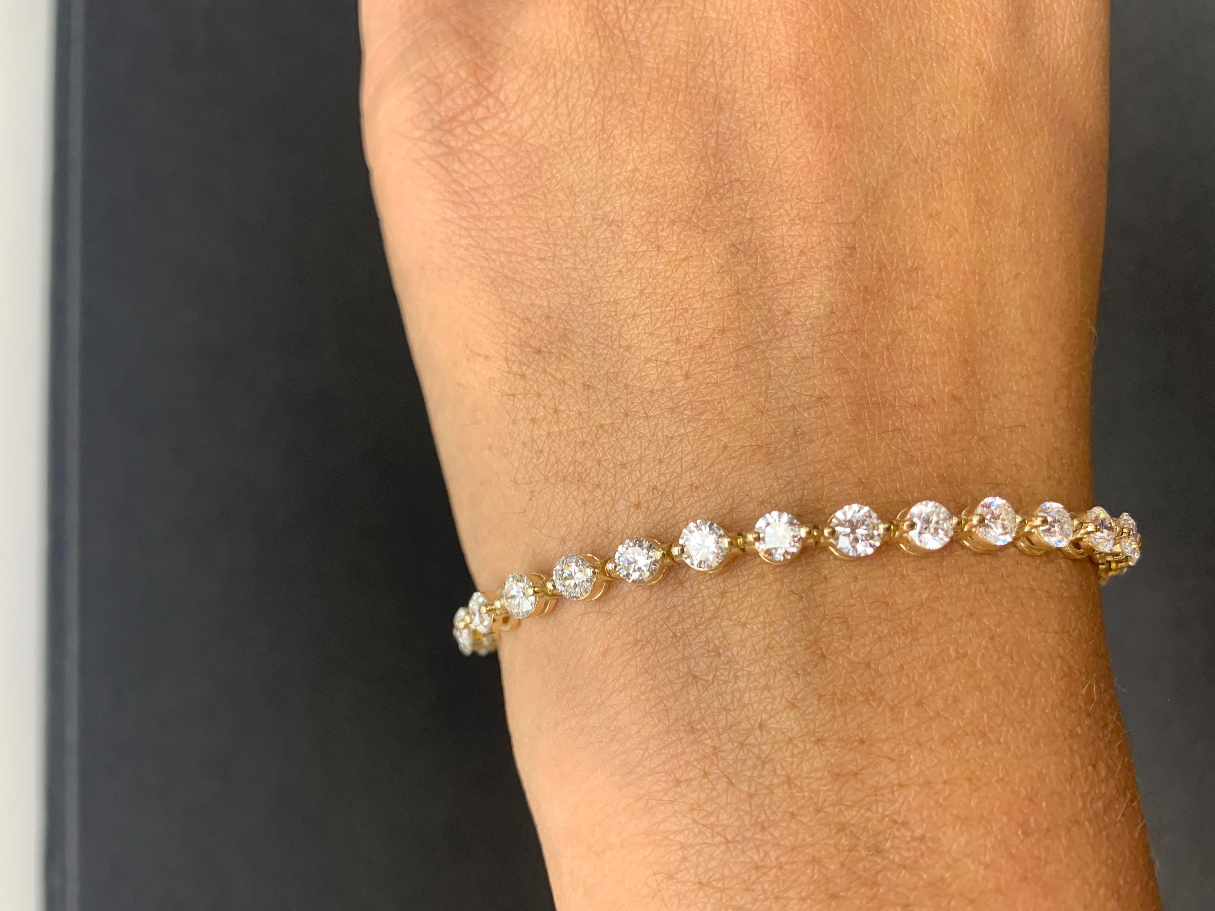 A stunning bracelet set with 32 Brilliant cut Diamonds weighing 7.01 carats total.  Set in polished 14k yellow gold. Double lock mechanism for maximum security. A simple yet dazzling piece.

All diamonds are GH color SI1 Clarity.
Available in white