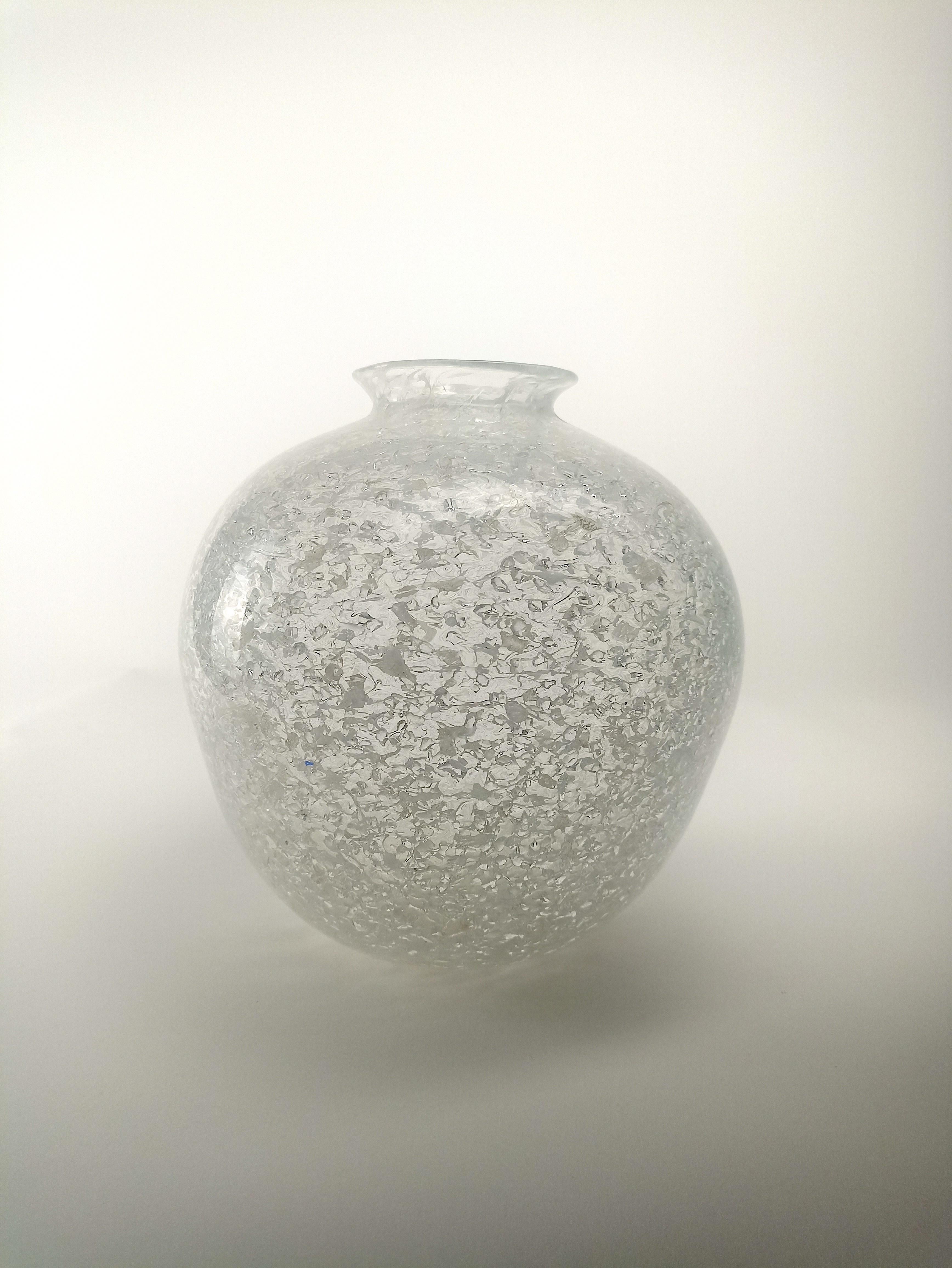 Elevate your home decor with the unique and captivating Grandinato vase. Crafted with a distinct glass working technique, this vase showcases the artistry and skill of the renowned Fratelli Toso glass factory. The interior of the vase is adorned
