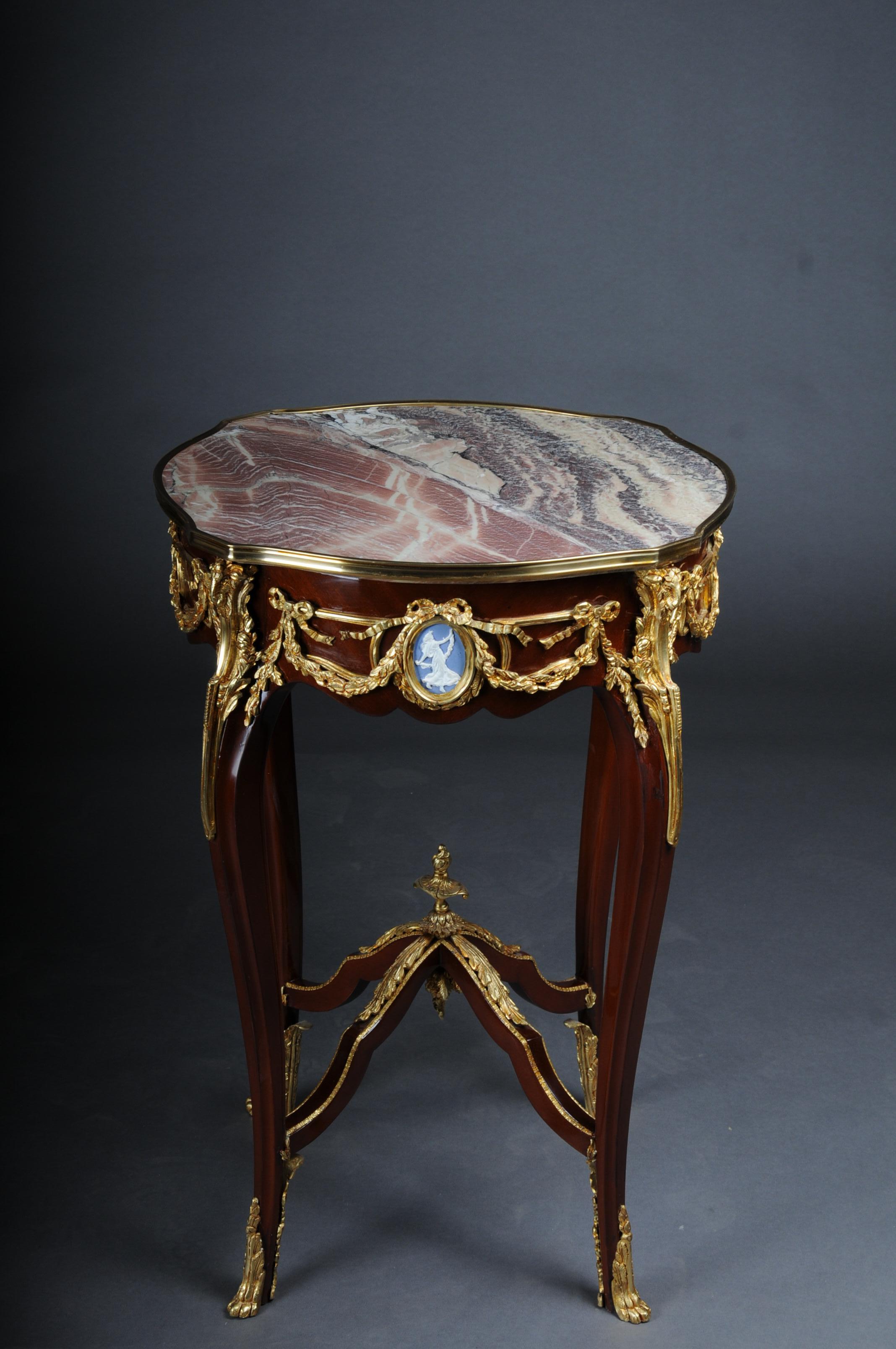 20th Century Grandiose side table with bronze Louis XV marble beech wood

Body made of solid beech wood with rich brass bronze decorations, gilded. Round marbled cover plate with gilded frame. The marble top has a stunning mottle. Each frame strip