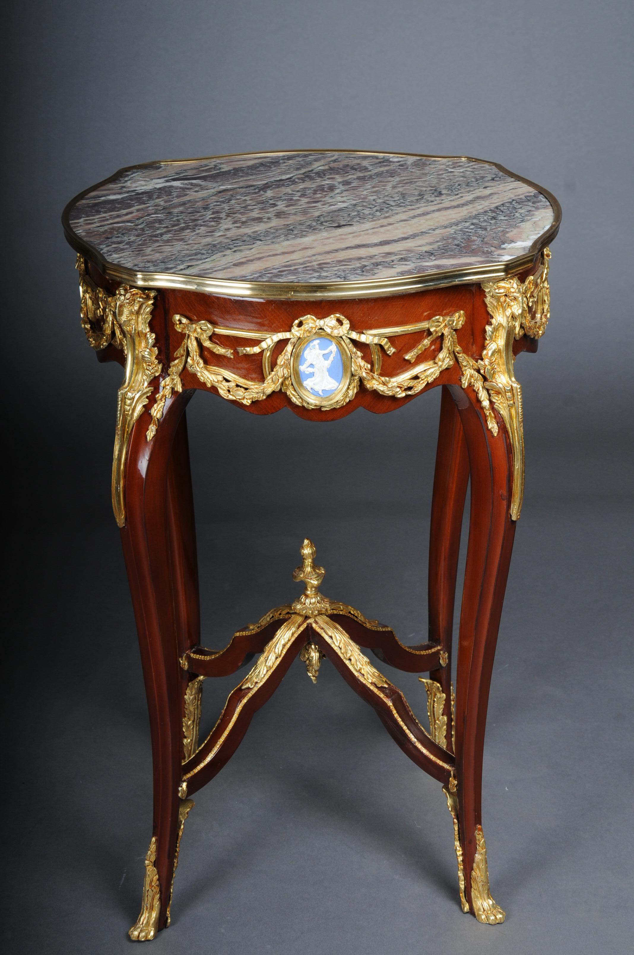 20th Century Grandiose side table with bronze Louis XV marble beech wood

Body made of solid beech wood with rich brass bronze decorations, gilded. Round marbled cover plate with gilded frame. The marble top has a stunning mottle. Each frame strip