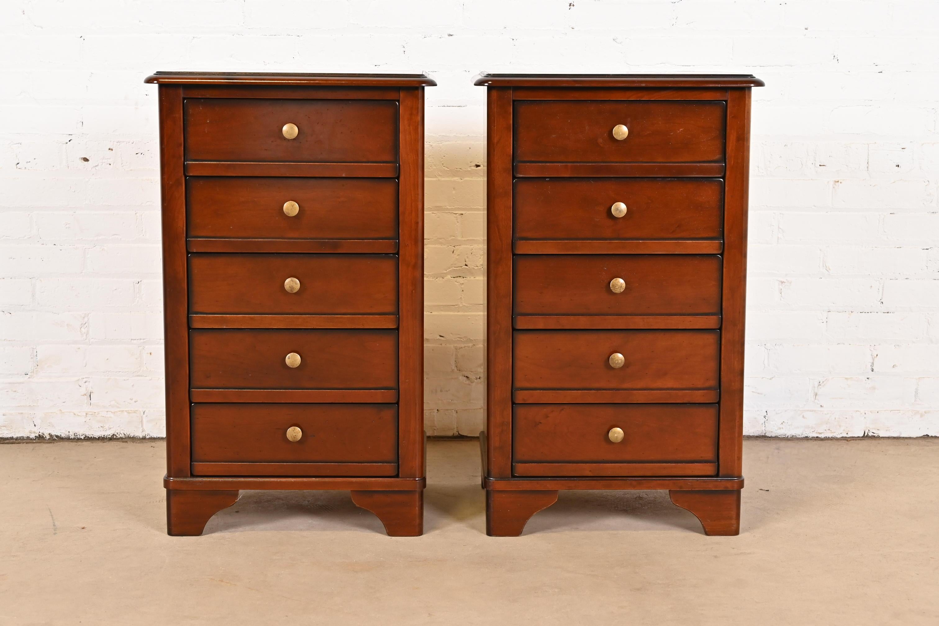 A gorgeous pair of French Louis Philippe style five-drawer nightstands or chests of drawers

By Grange

France, Circa Late 20th Century

Solid cherry wood, with original brass hardware.

Measures: 18