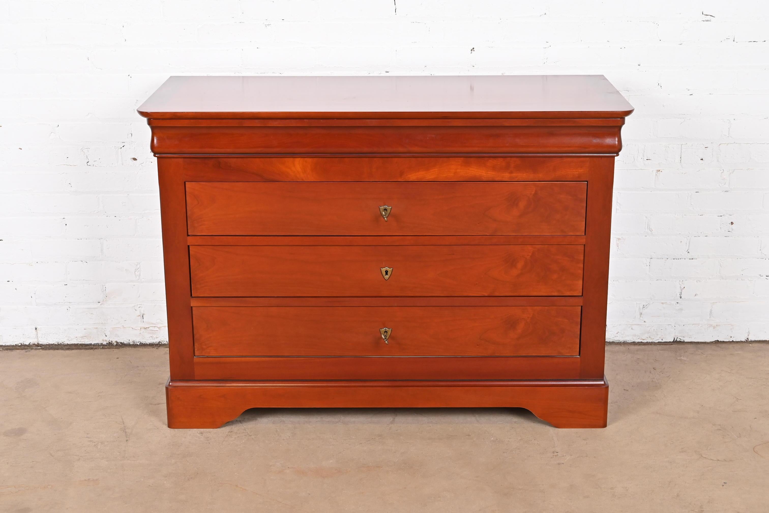 A gorgeous French Louis Philippe style dresser, commode, or chest of drawers

By Grange

France, Circa Late 20th century.

Solid cherry wood, with original brass hardware. Drawers lock, and key is included.

Measures: 46.5