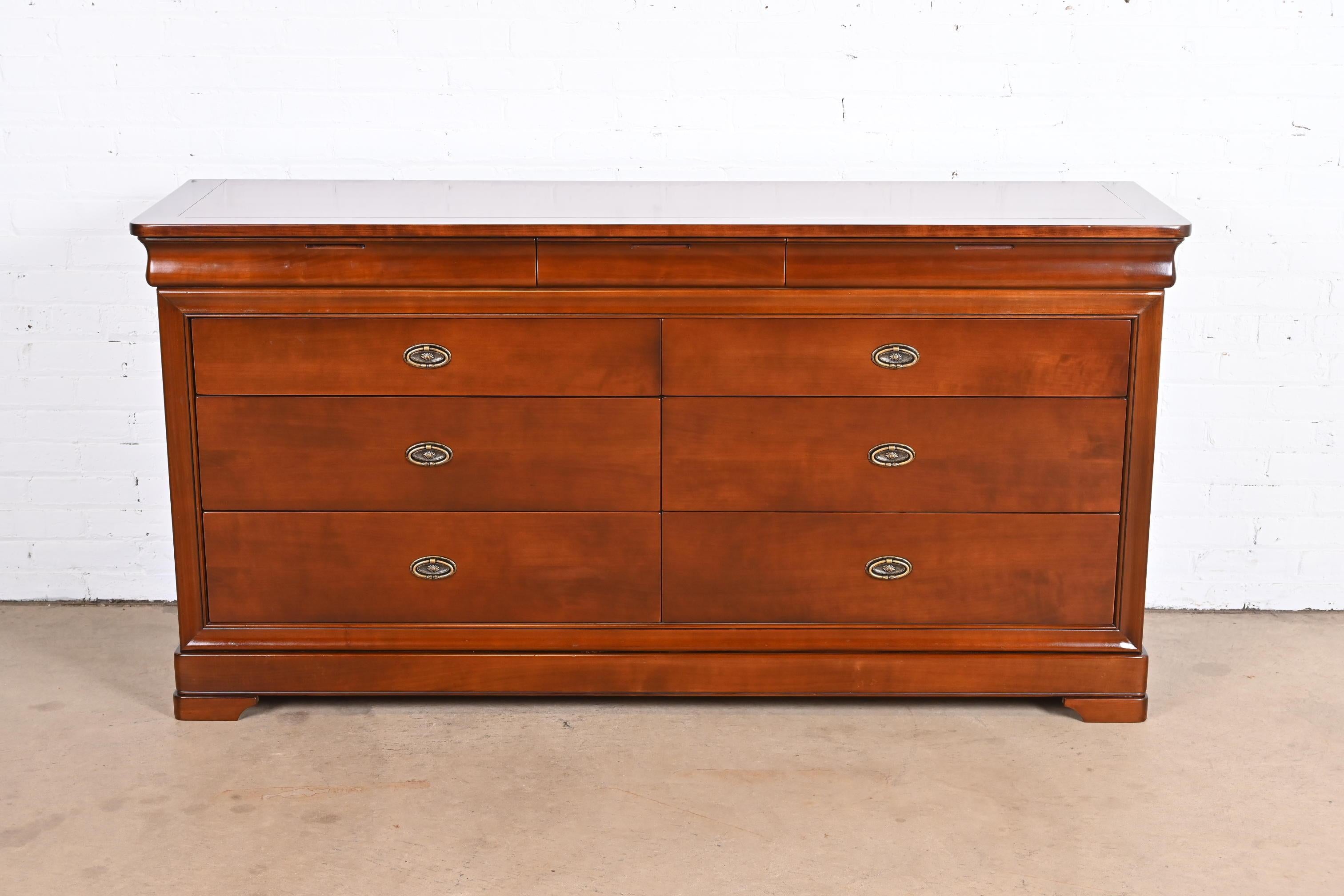 A gorgeous French Louis Philippe style nine-drawer long dresser or credenza

By Grange

France, Late 20th Century

Solid cherry wood, with original brass hardware.

Measures: 69.13