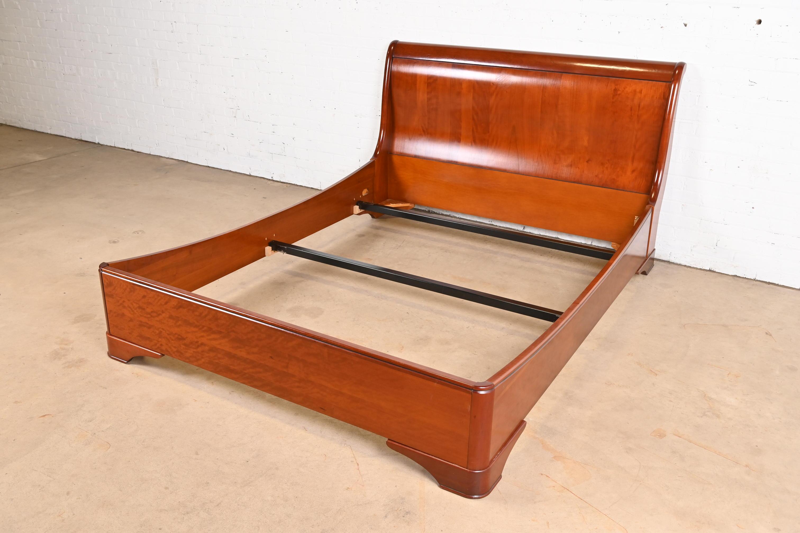 A gorgeous French Louis Philippe or Empire style solid cherry wood queen size sleigh bed

By Grange

France, Circa Late 20th Century

Measures: 65.38