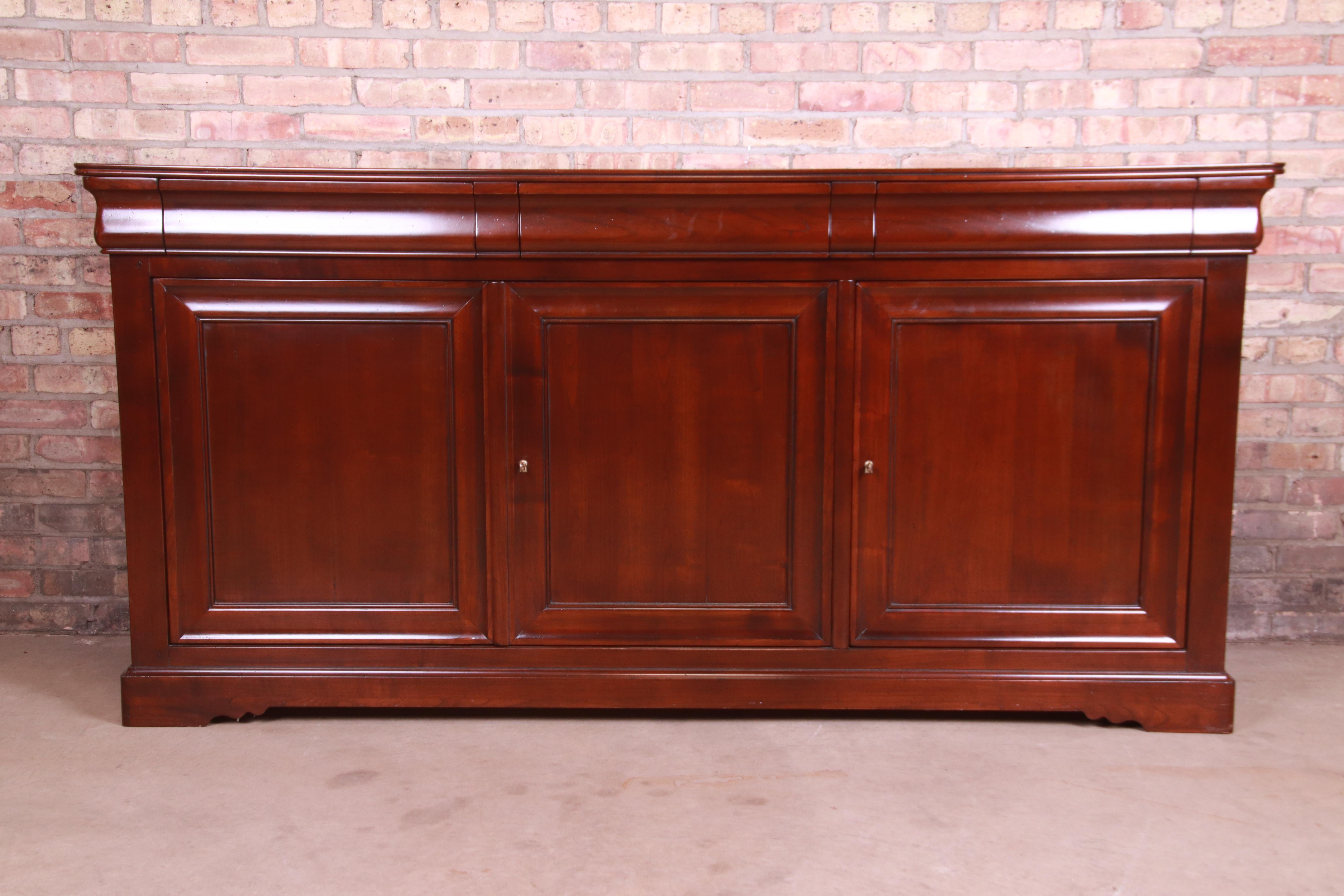 A gorgeous French Provincial solid cherry wood sideboard, credenza, or bar cabinet

By Grange,

France, 2000

Measures: 74.5