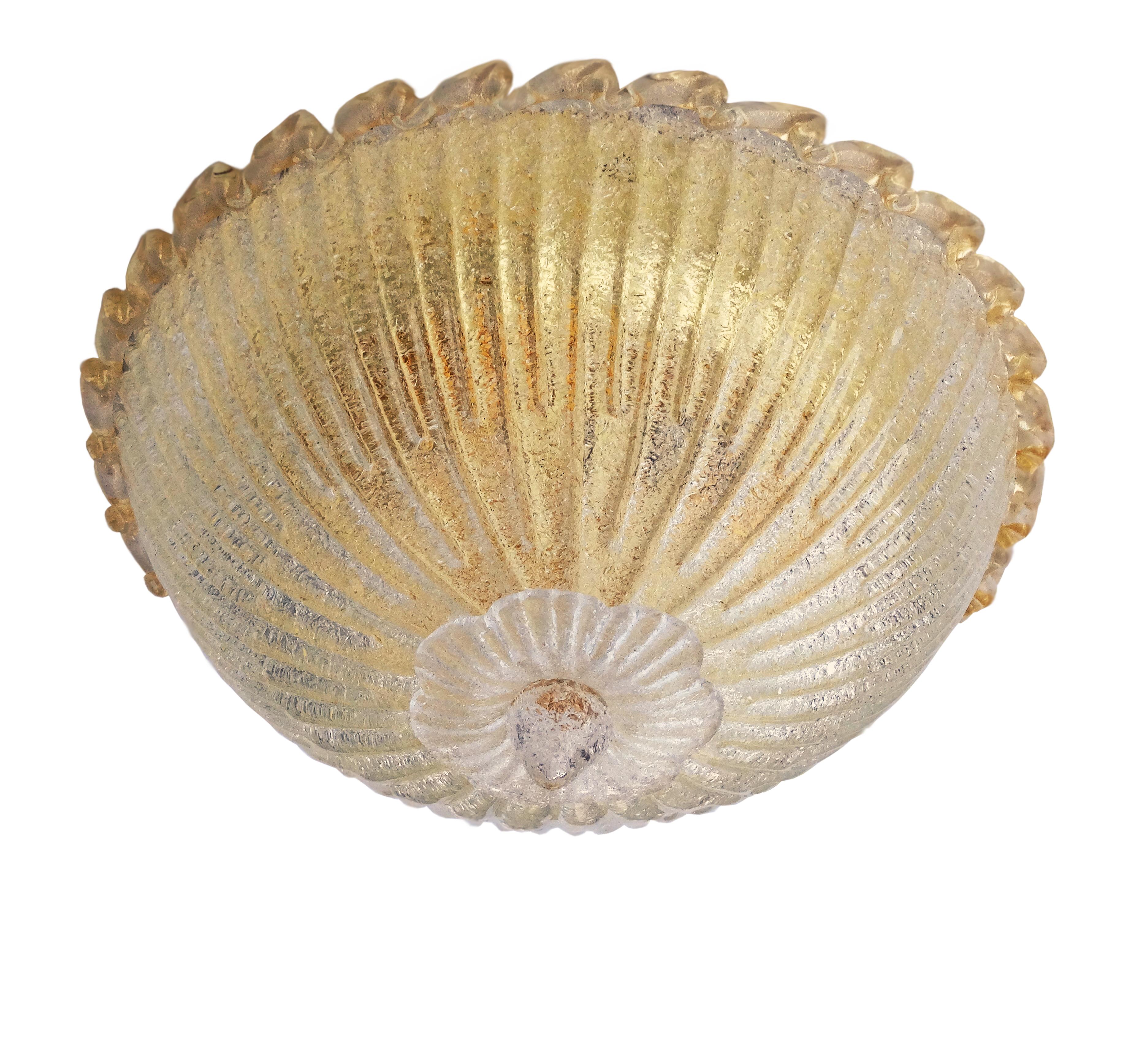 Italian flush mount with a Murano glass diffuser hand blown in Graniglia technique to produce granular textured effect with gold flecks, mounted on gold plated finish frame / Made in Italy
Measures: diameter 16 inches, height 9.5 inches
3 lights /
