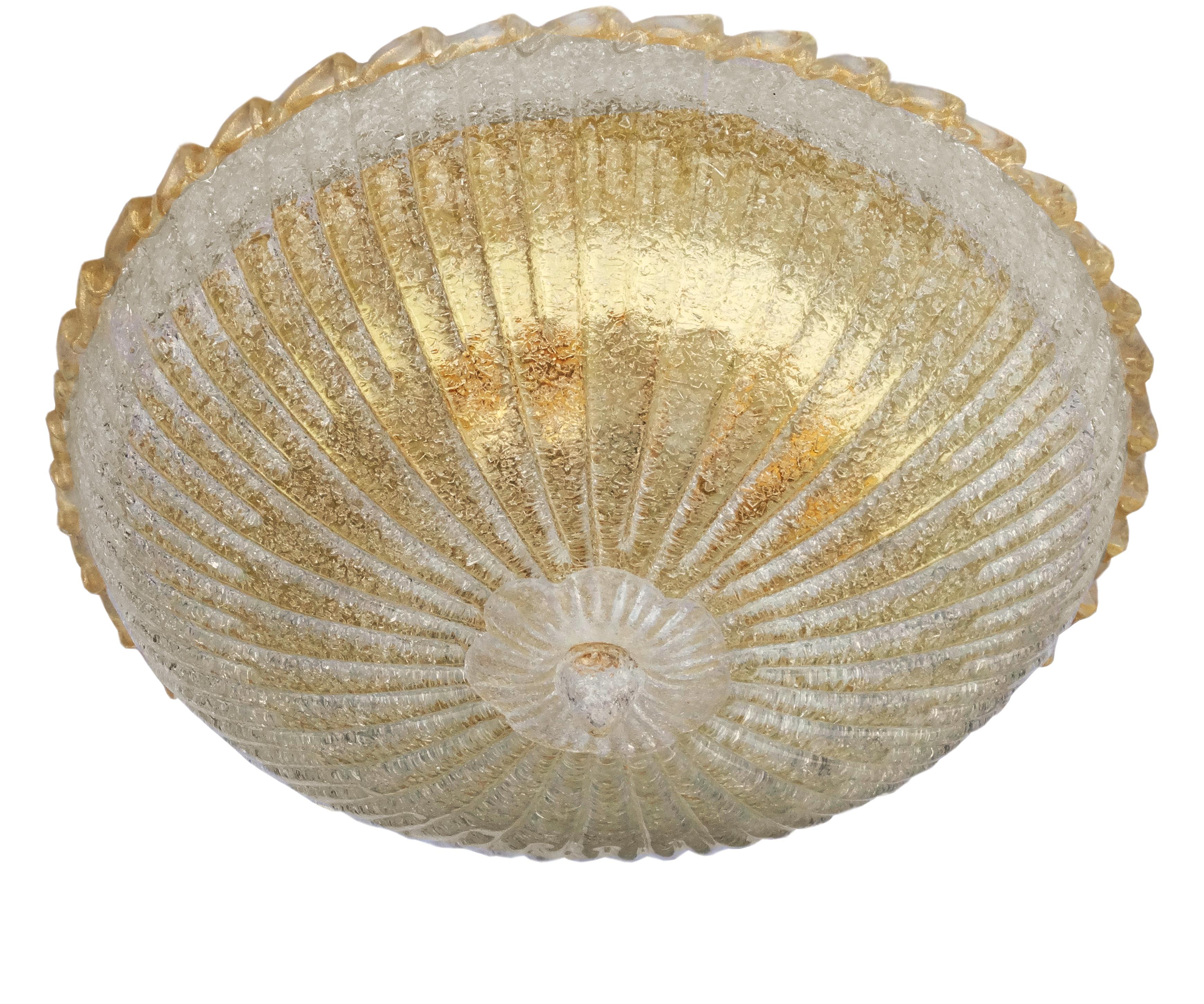 Italian flush mount with a Murano glass diffuser hand blown in Graniglia technique to produce granular textured effect with gold flecks, mounted on gold-plated finish frame / Made in Italy
Measures: diameter 20 inches, height 9 inches
3 lights / E26