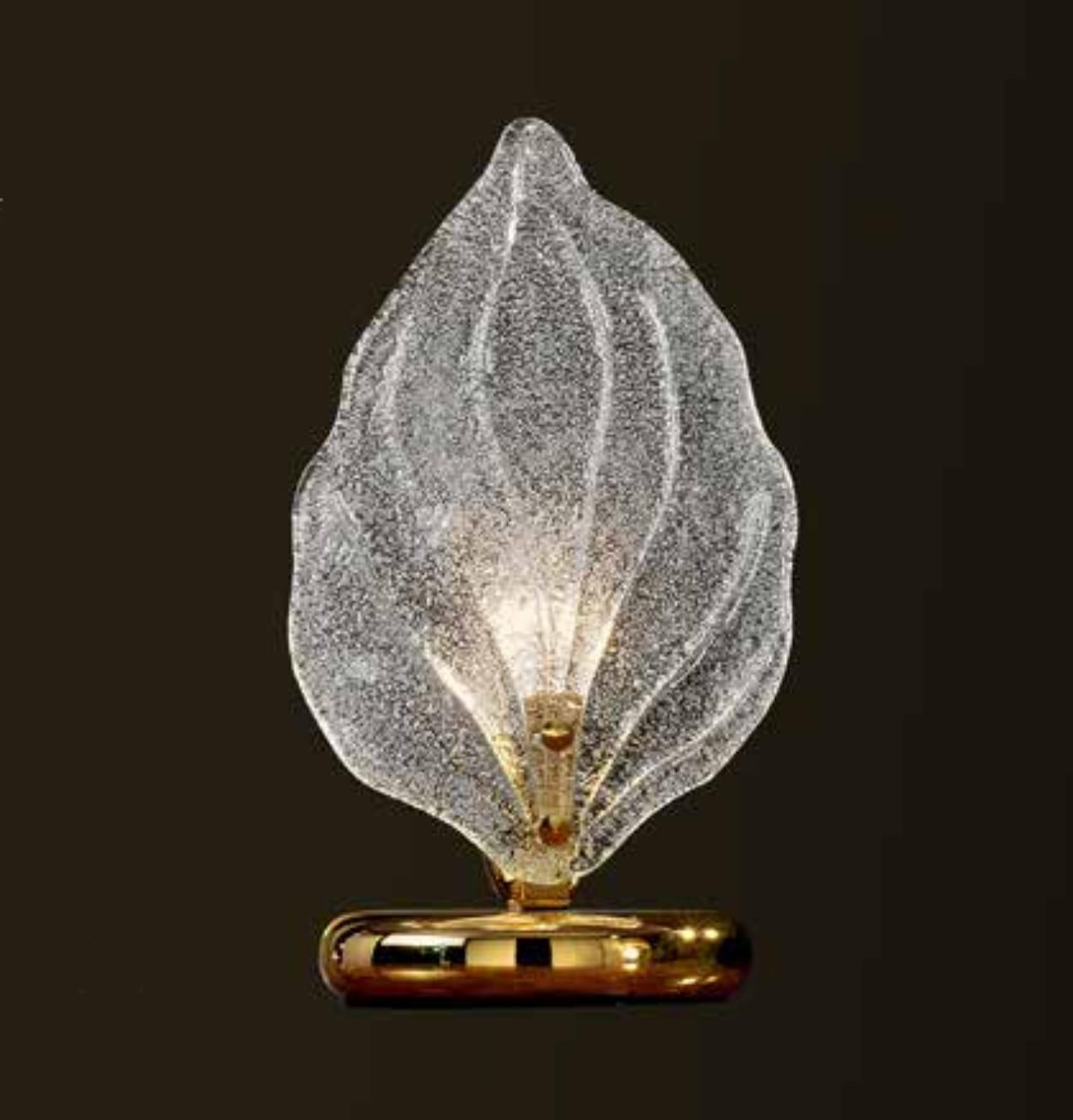 Italian table lamp with a large Murano glass leaf hand blown in Graniglia technique to produce granular textured effect, supported by gold finish metal base / Made in Italy
1 light / E12 or E14 type / max 40W 
Measures: diameter 5.5 inches, height