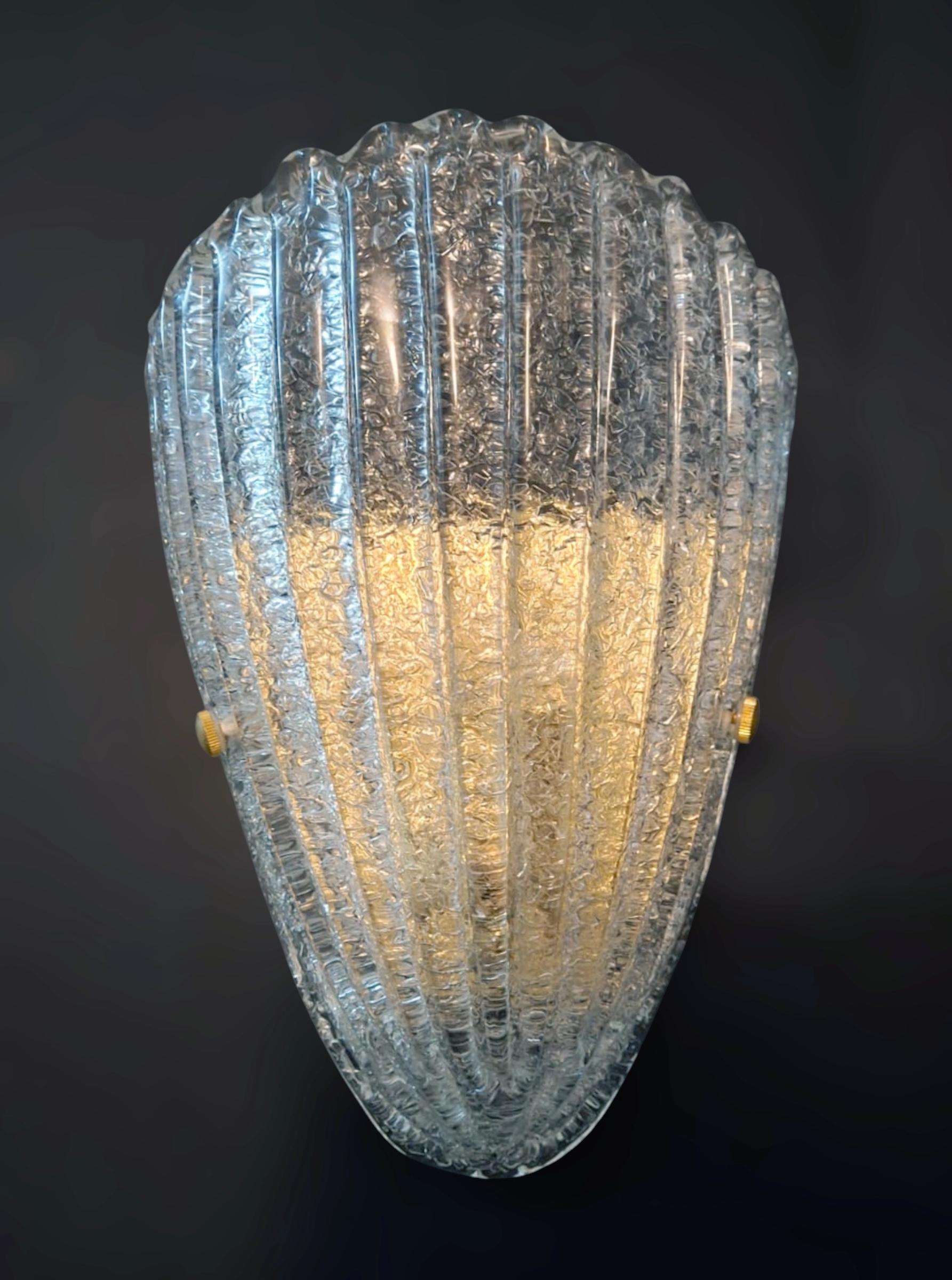 Italian wall light with a Murano glass shield hand blown in Graniglia technique to produce granular textured effect, mounted on gold frame / Made in Italy
Measures: Height 12.5 inches, width 9 inches, depth 4.5 inches
1 light / E26 or E27 type / max