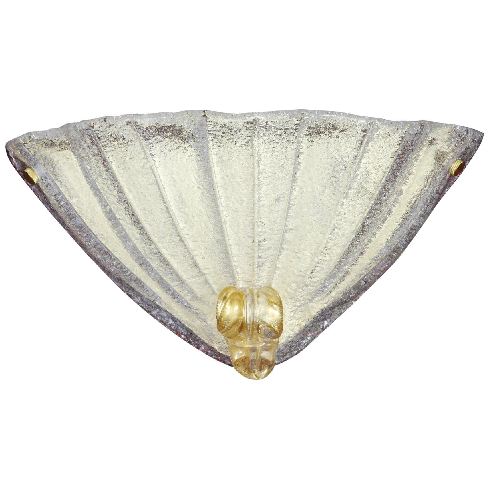 Italian wall light with a Murano glass shield hand blown in Graniglia technique to produce granular textured effect with gold flecks, mounted on gold-plated finish frame / Made in Italy
Measures: Height 9 inches, width 16 inches, depth 6 inches
1