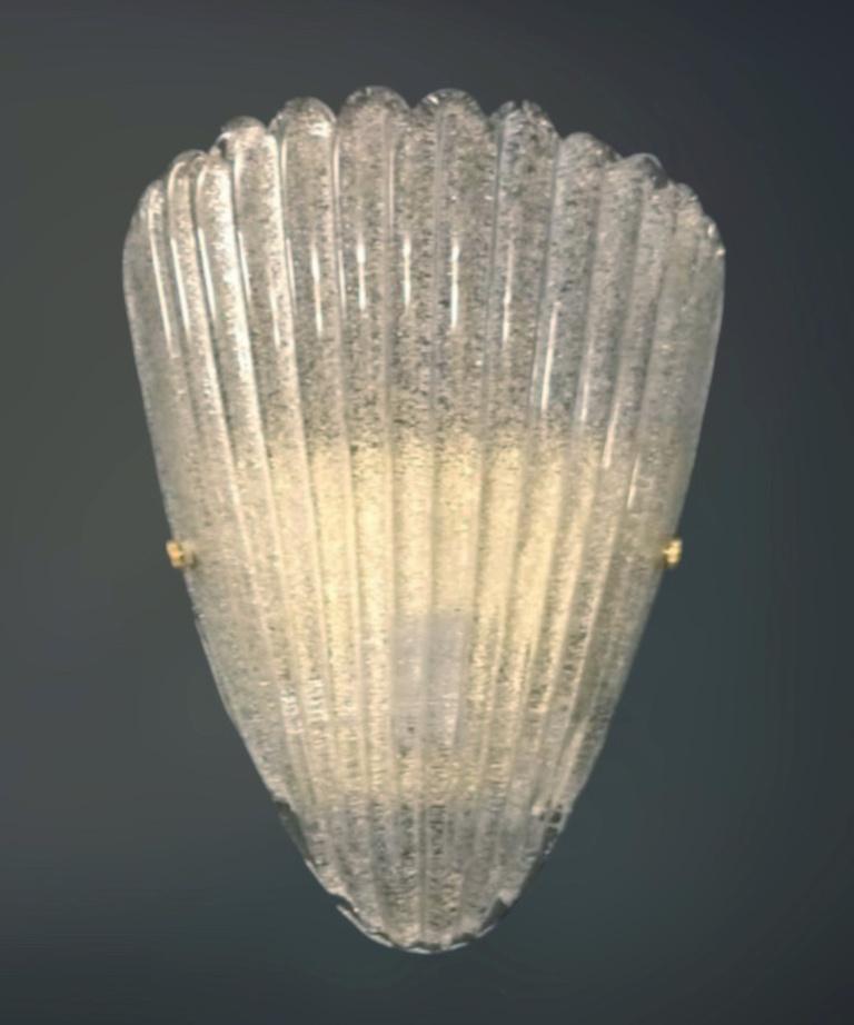 Italian wall light with a Murano glass shield hand blown in Graniglia technique to produce granular textured effect, mounted on gold frame / Made in Italy
Measures: Height 12 inches, width 10 inches, depth 4 inches
1 light / E26 or E27 type / max