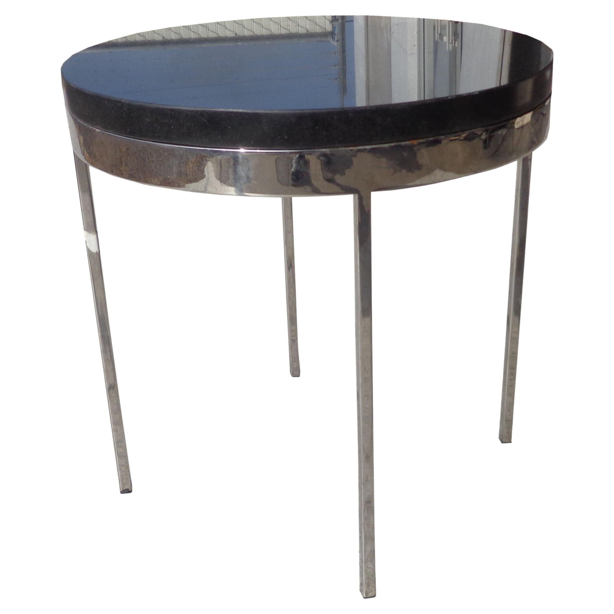 Granite and chrome side table in the style of Nicos Zographos

Polished chrome base with a black granite top. 

Measures: 18.5