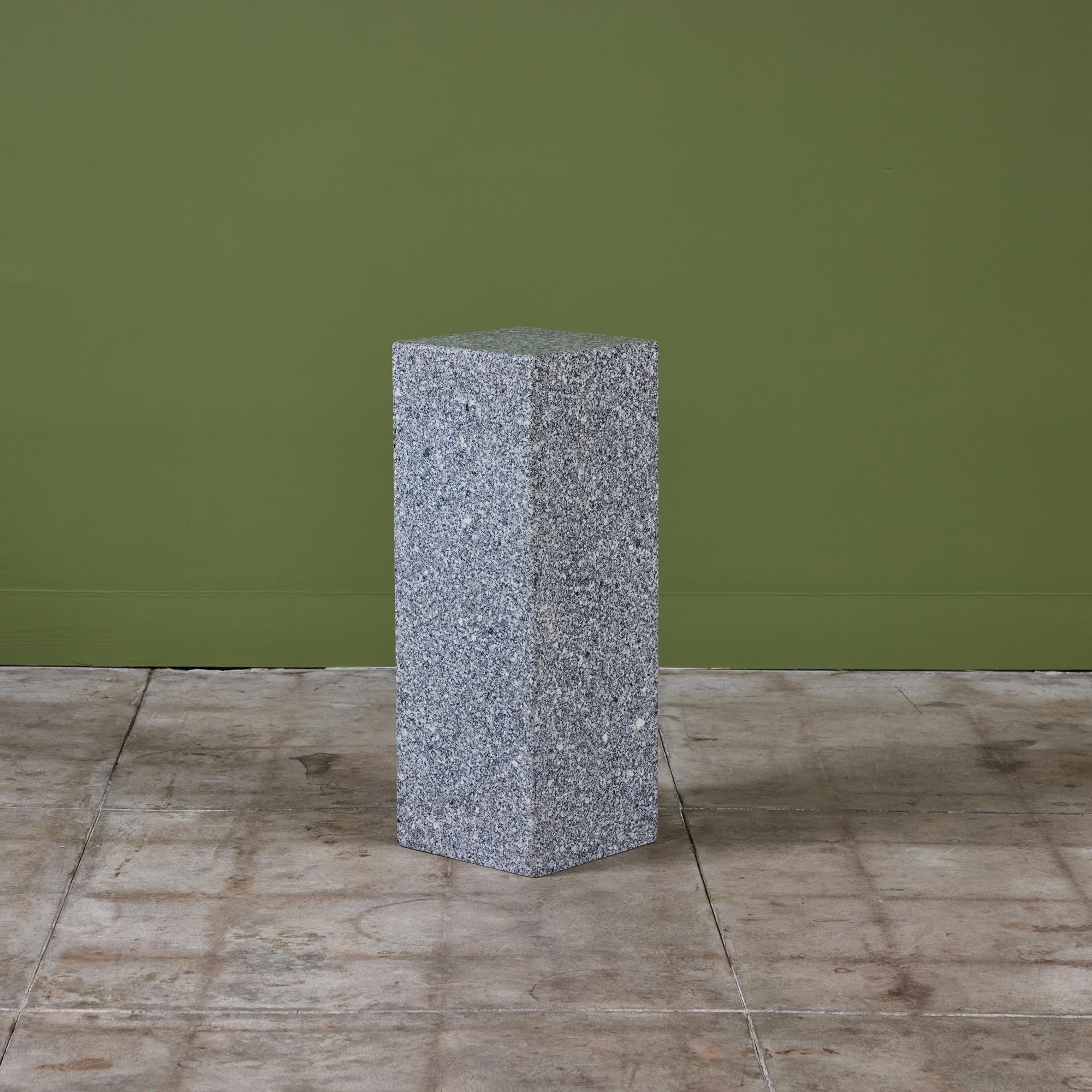 Stone pedestal in a beautiful speckled granite of grey, black and white. This timeless piece can be a sculptural piece of art or it can beautifully display whatever object rests upon it. The square pedestal has four sides with soft rounded