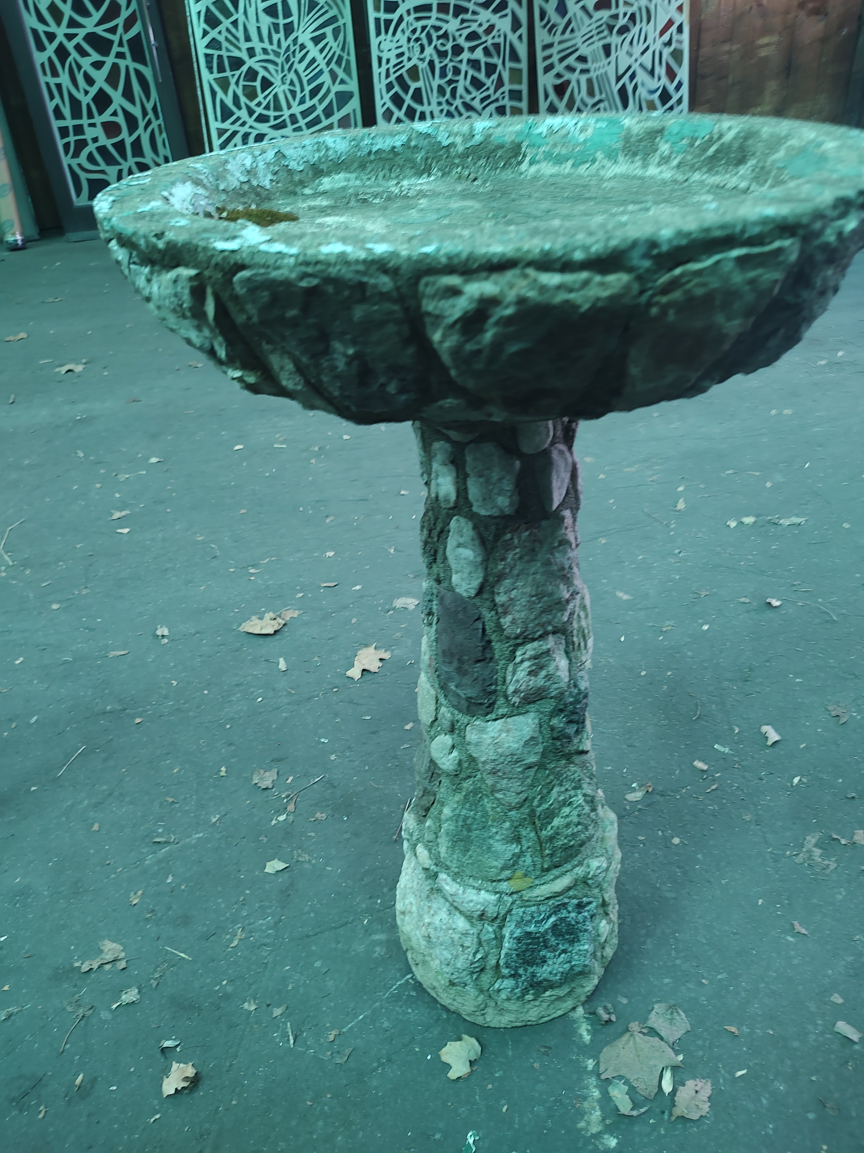 Fabulous cast stone birdbath with granite rocks set in place throughout the base and dish body. This will be sealed using a eco-friendly sealer to ensure that it holds water. One piece construction.