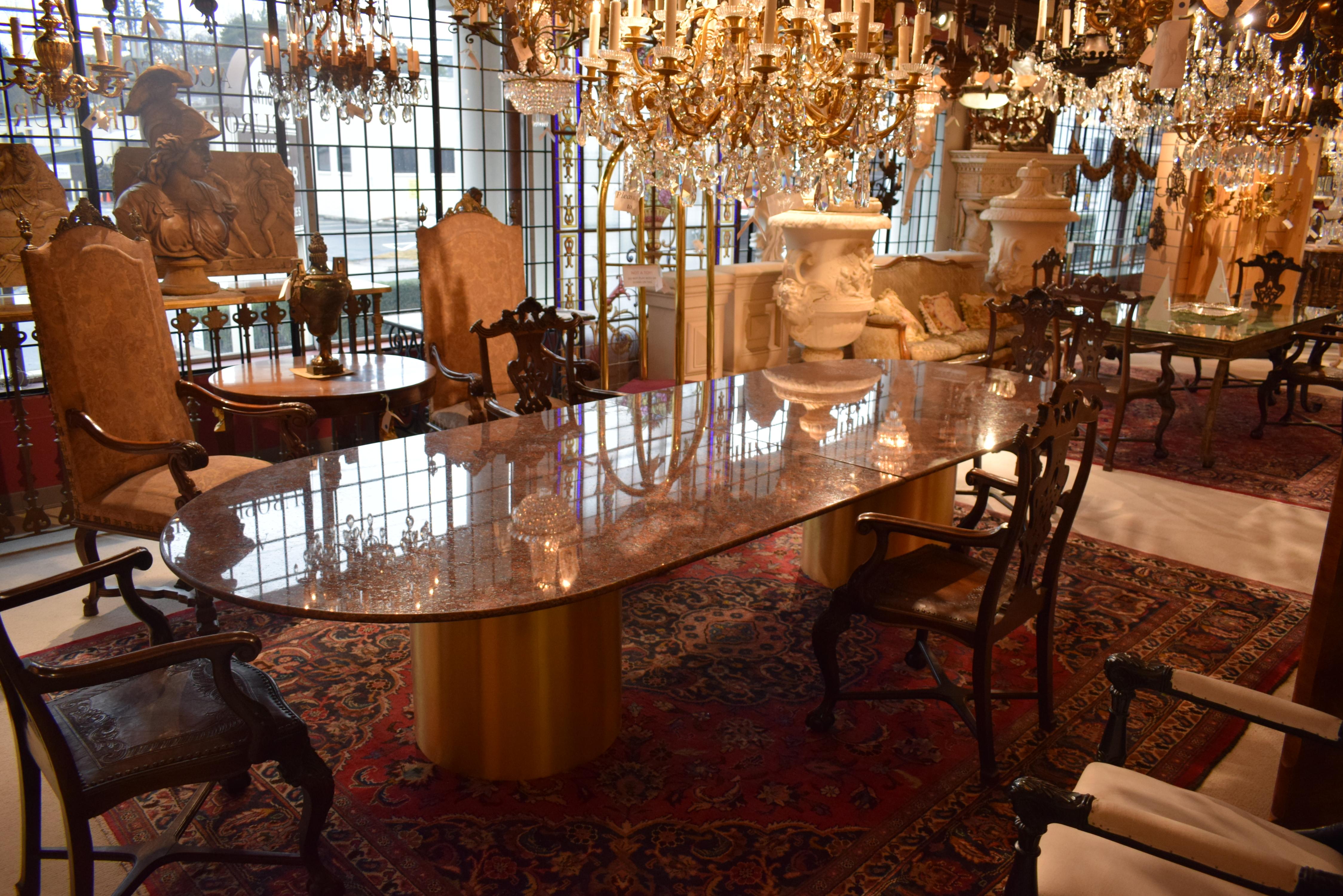 A Superb Granite top conference table raised on two cylindrical bronze veneered legs. Iron support (not seen) structure.