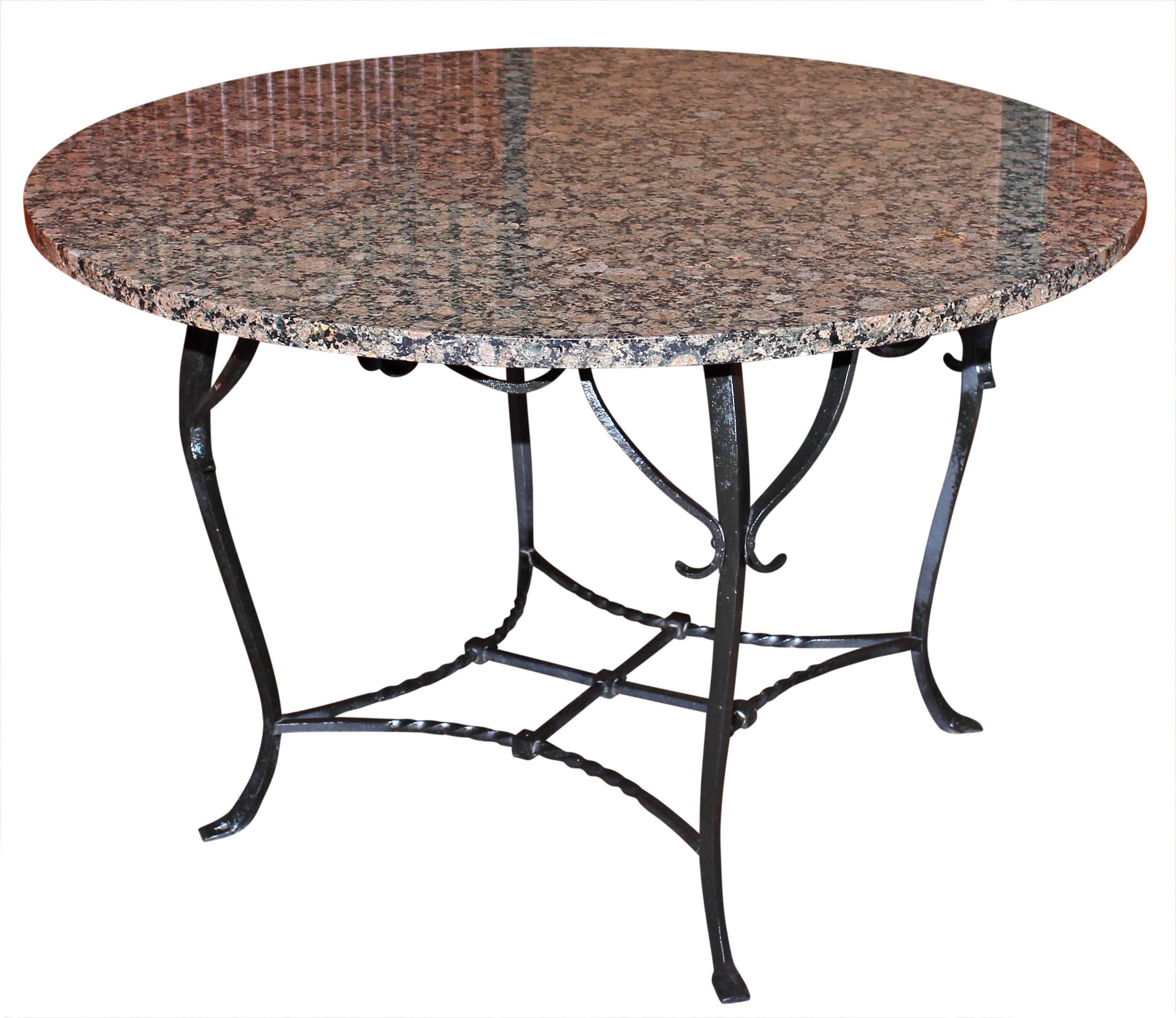 Antique wrought iron and granite dining table. Base is handmade. Table is strong and solidly built. Made circa 1910. Table may be used indoors or outdoors.