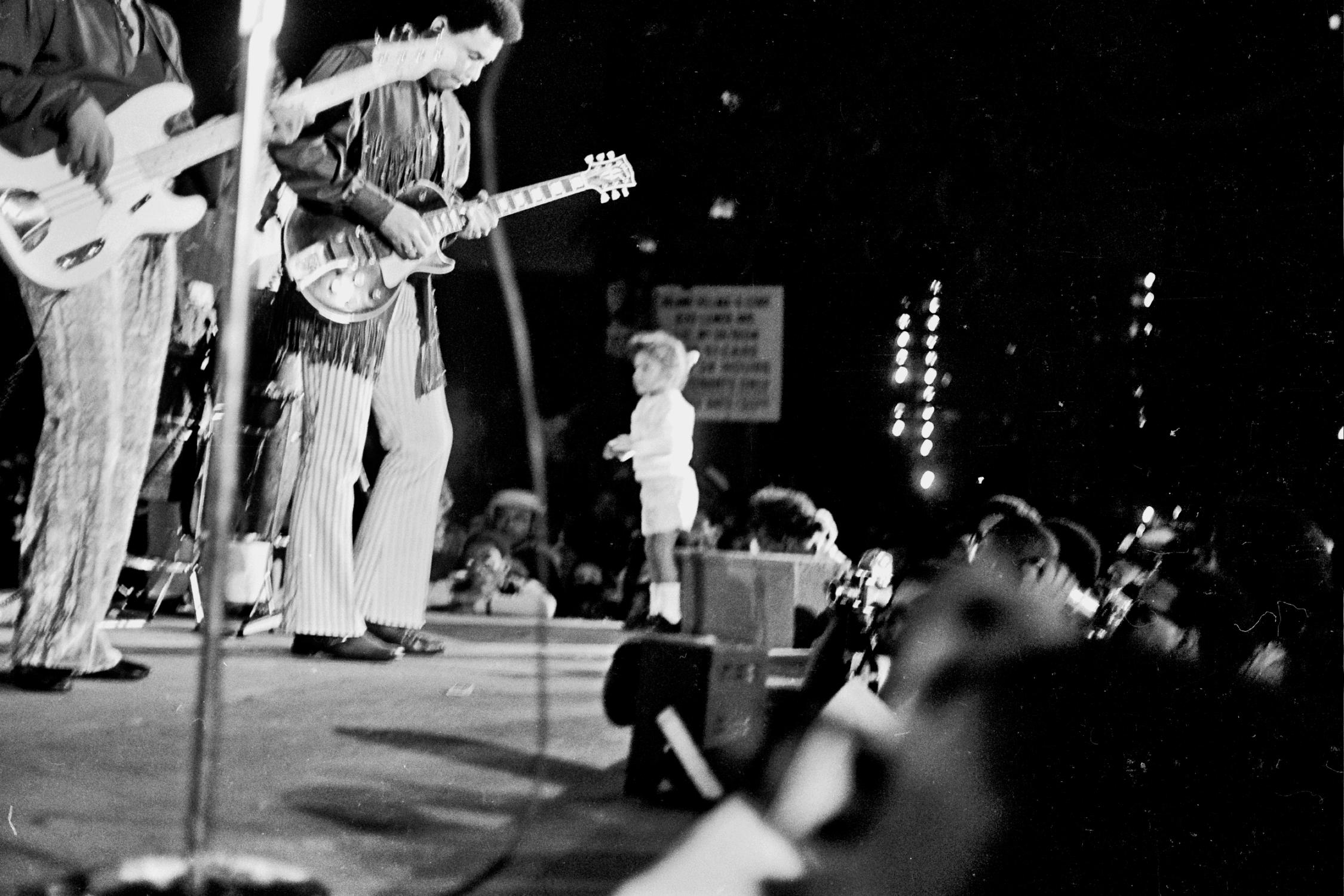 Grant Harper Reid Black and White Photograph - Child Running on Stage During Jimi Hendrix and the Experience Fine Art Print