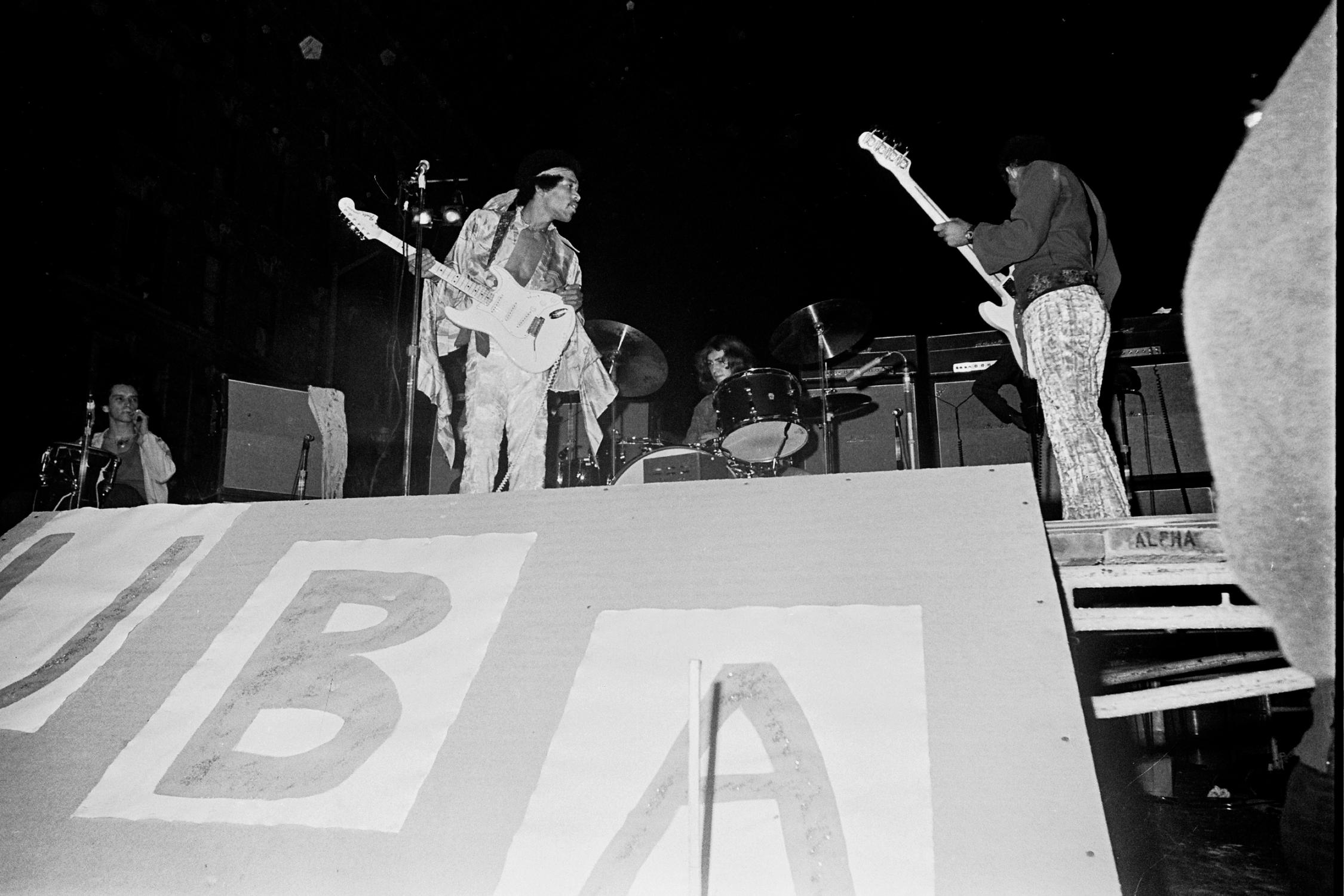 Grant Harper Reid Black and White Photograph - Jimi Hendrix Playing with Band Shot From Below Fine Art Print