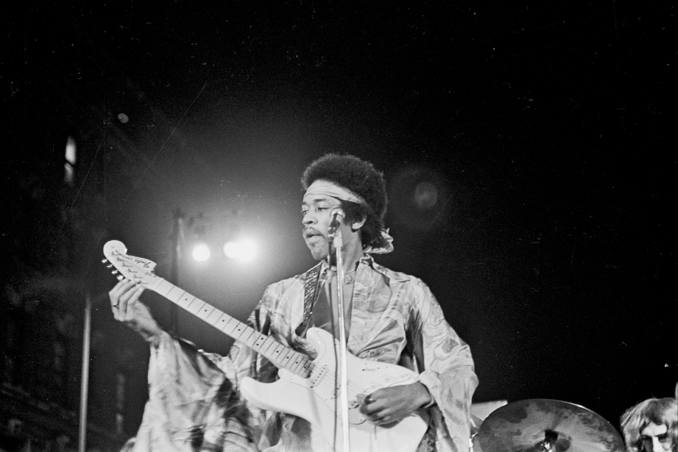 Grant Harper Reid Black and White Photograph - Jimi Hendrix Tuning Guitar on Stage Fine Art Print