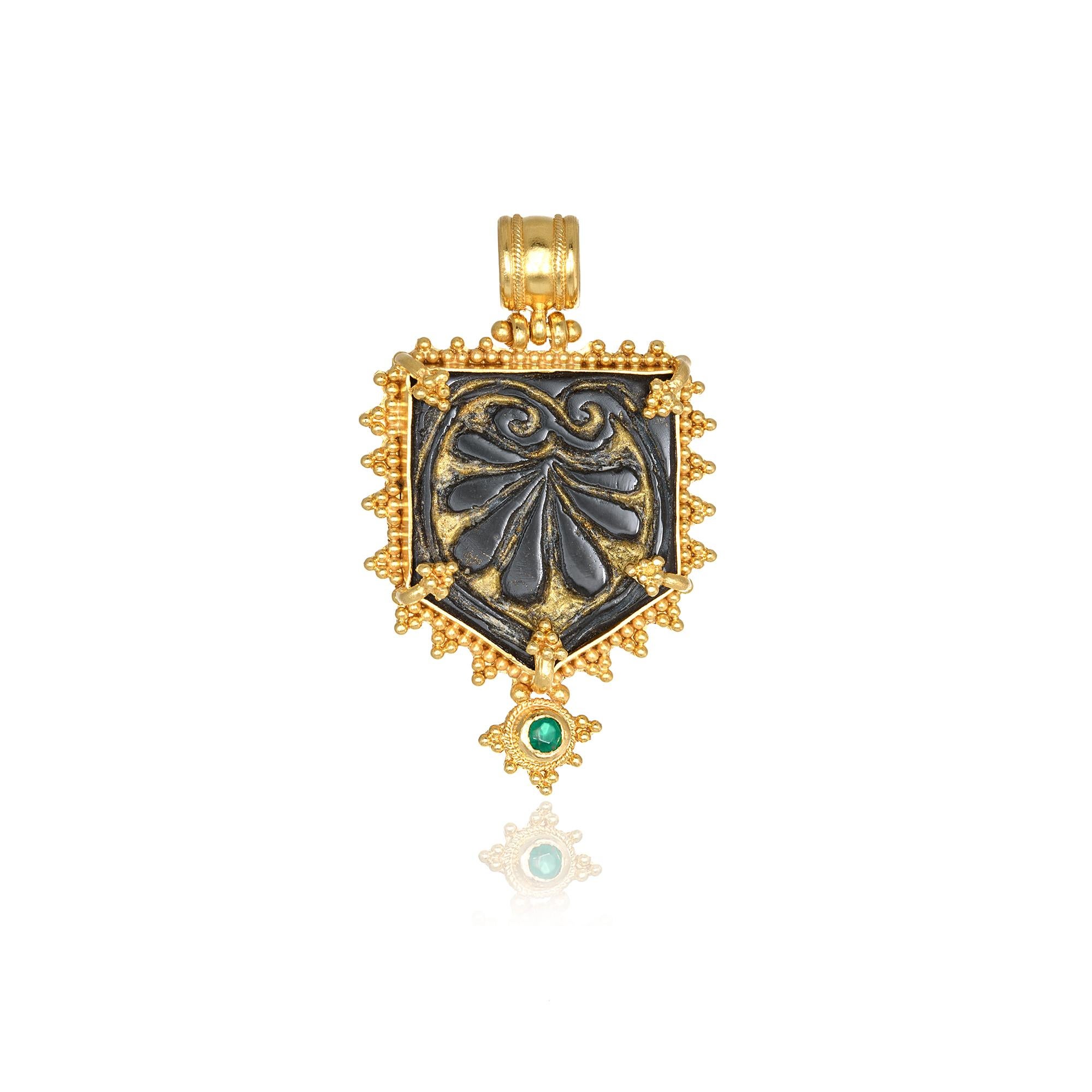 Obsidian hand carved pendant necklace handcrafted in 22Kt yellow gold, featuring a round Emerald. Inspired by the greek nature, Nicofilimon designed this breathtaking jewelry piece highlighting the elegant shilouete of an Acanthus Flower. The minute