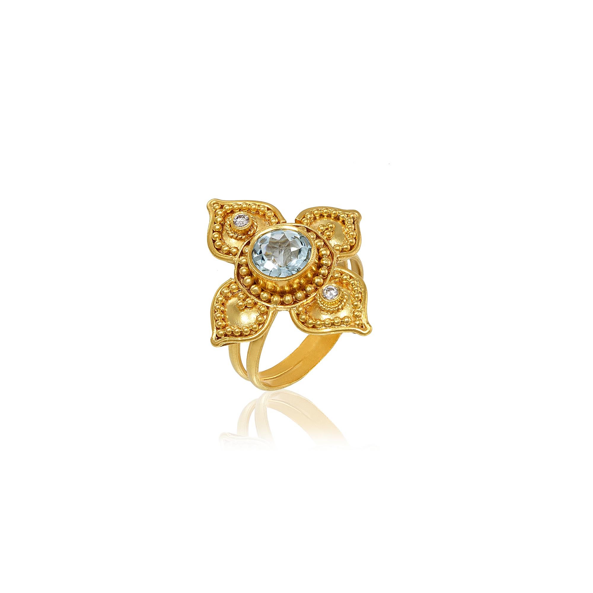 Byzantine four-petal flower cocktail ring handcrafted in 22Kt yellow gold, featuring an Aquamarine center and two brilliant cut diamonds on the petals. Granulation and Filigree techniques are applied in bold ways to create exquisite pieces of