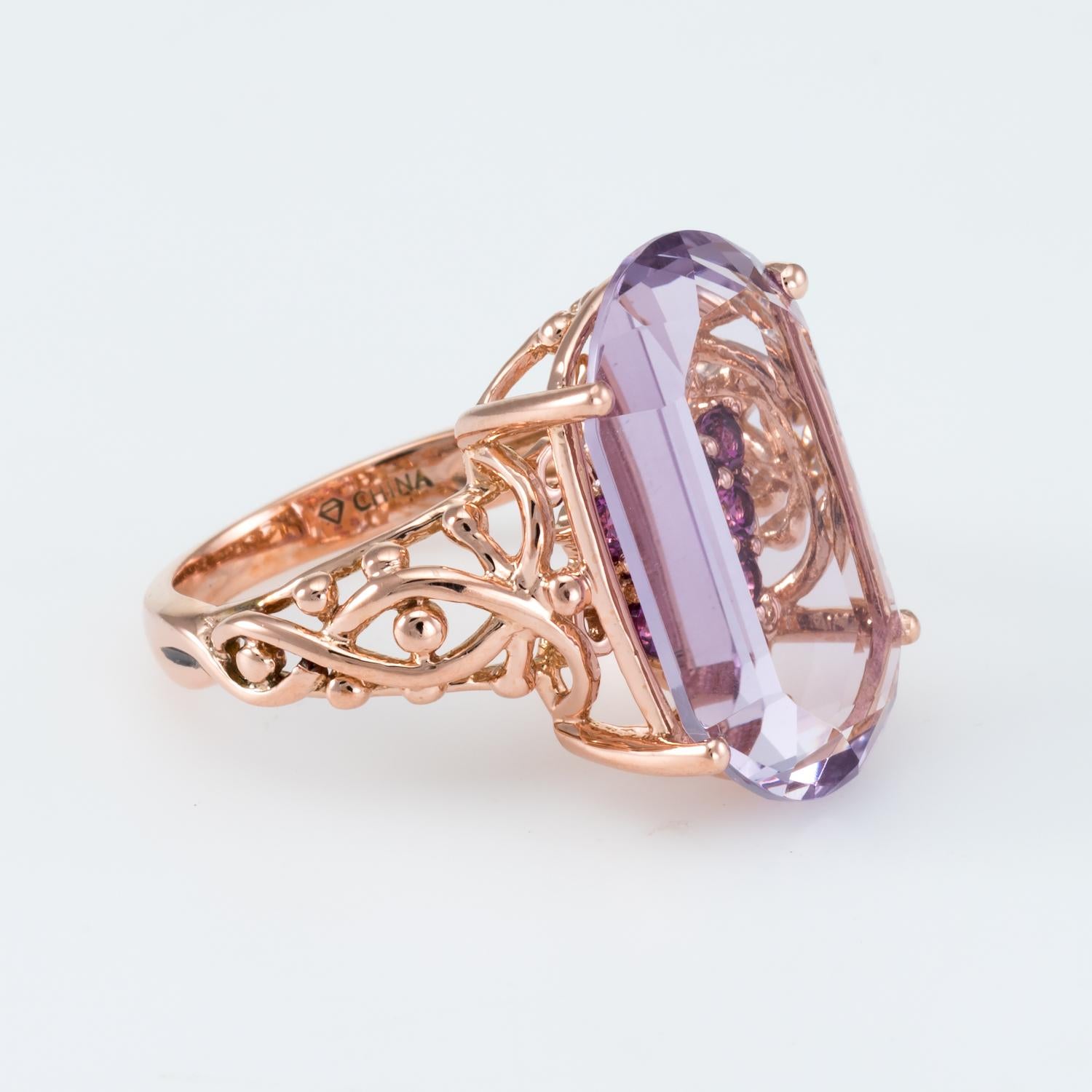 Elegant estate cocktail ring, crafted in 14 karat rose gold. 

Rubies total an estimated 0.32 carats, accented with an estimated 0.02 carats of diamonds (estimated at I color and I1 clarity). The amethyst measures 20mm x 12mm and is estimated at 14