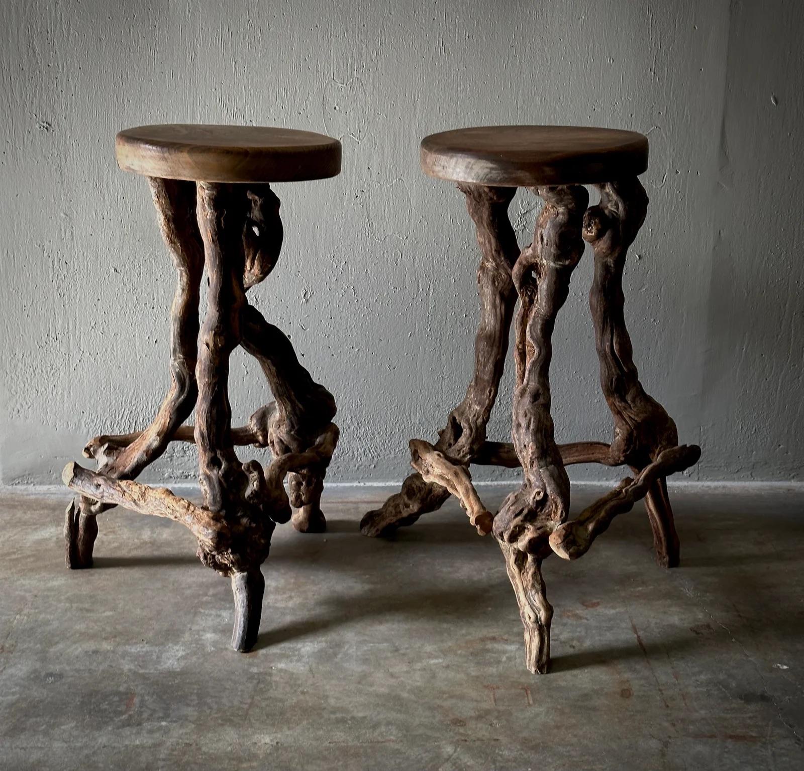 These French stools are expertly crafted from naturally twisted grapevines, each piece a unique testament to organic design. The circular wooden tops rest on entangled vine bases, showcasing the raw beauty of unadulterated wood. Ideal for adding a