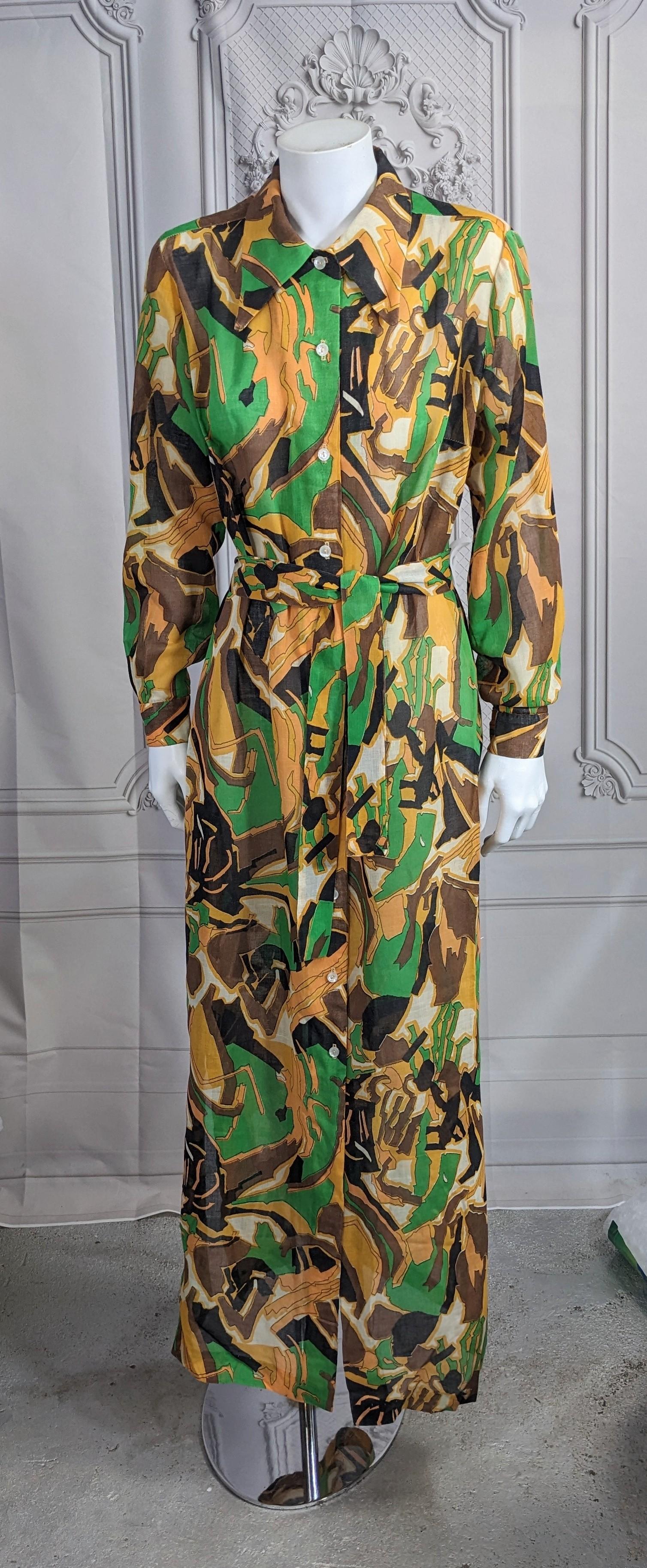 Striking 1970's Maxi Shirtwaist in cool semi sheer cotton blend in amazing graphic print. Straight full cut falling from small shoulders. Self fabric belt and side slits at hem. 1970's USA. 