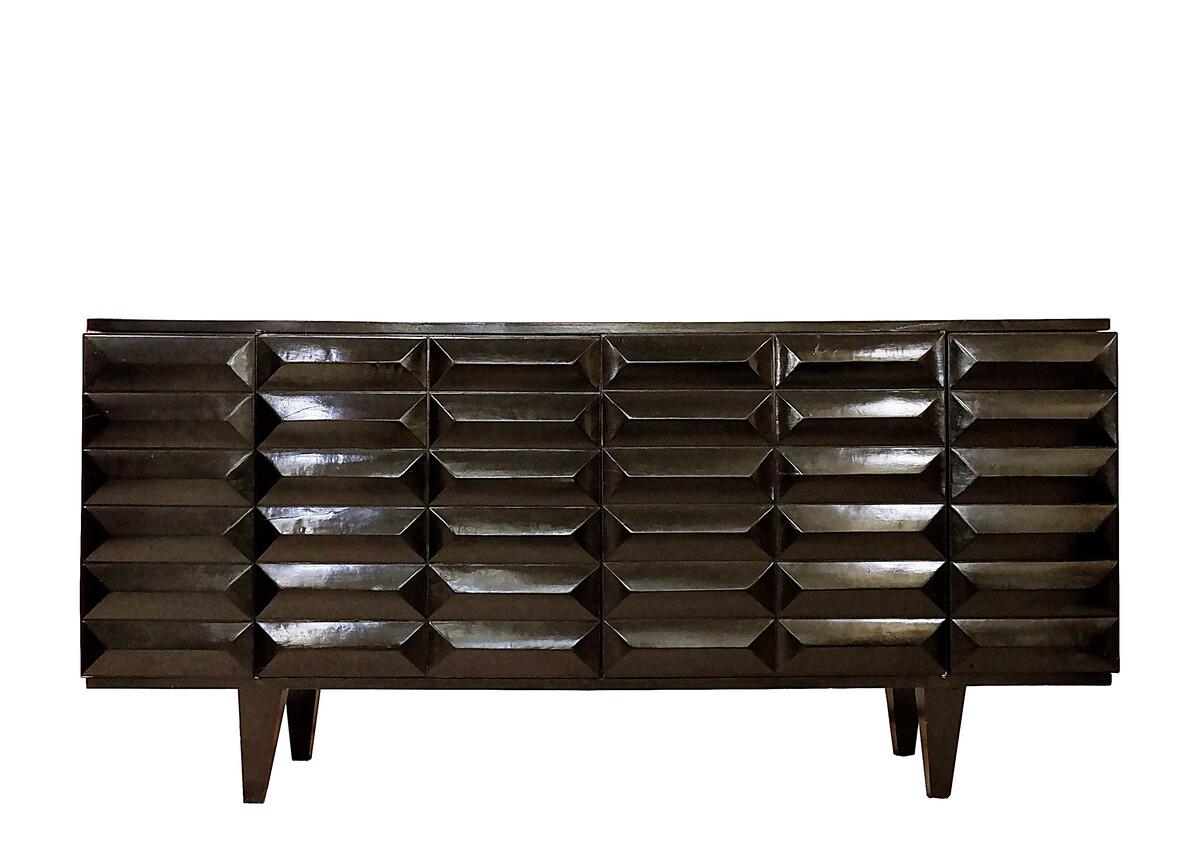Black sideboard with graphic surface made in the 1960's. The sides open on a reflective storage area, suggesting the sideboard can be used as a bar, along with the other end of the sideboard which opens on spacious shelves. 