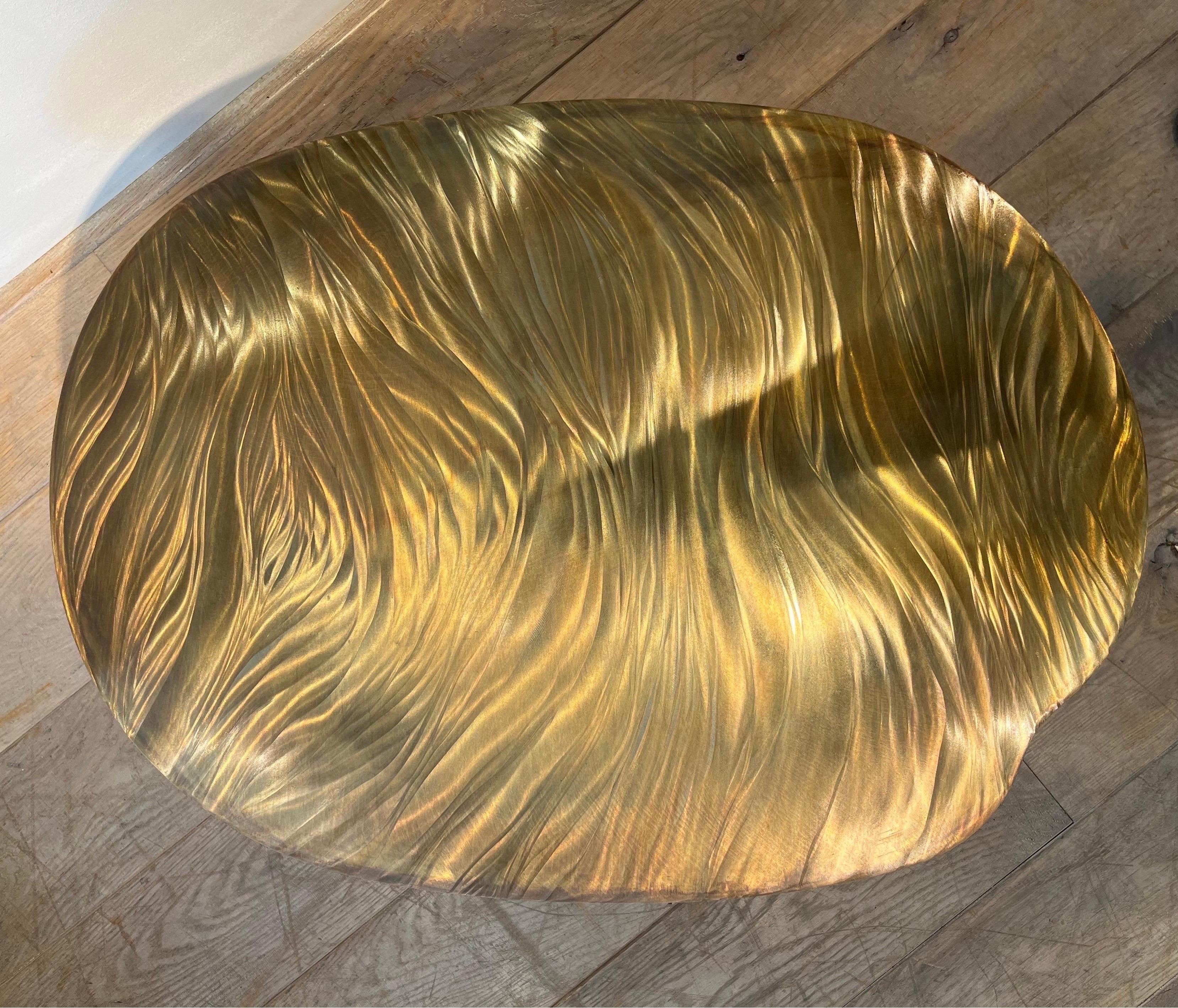 Christian Krekels is a Belgian designer who created decorative furniture from the 1970s. The present table is in brass, probably worked with acid and tool engraving technique. The shape is free formed. The design is abstract and has an interesting 