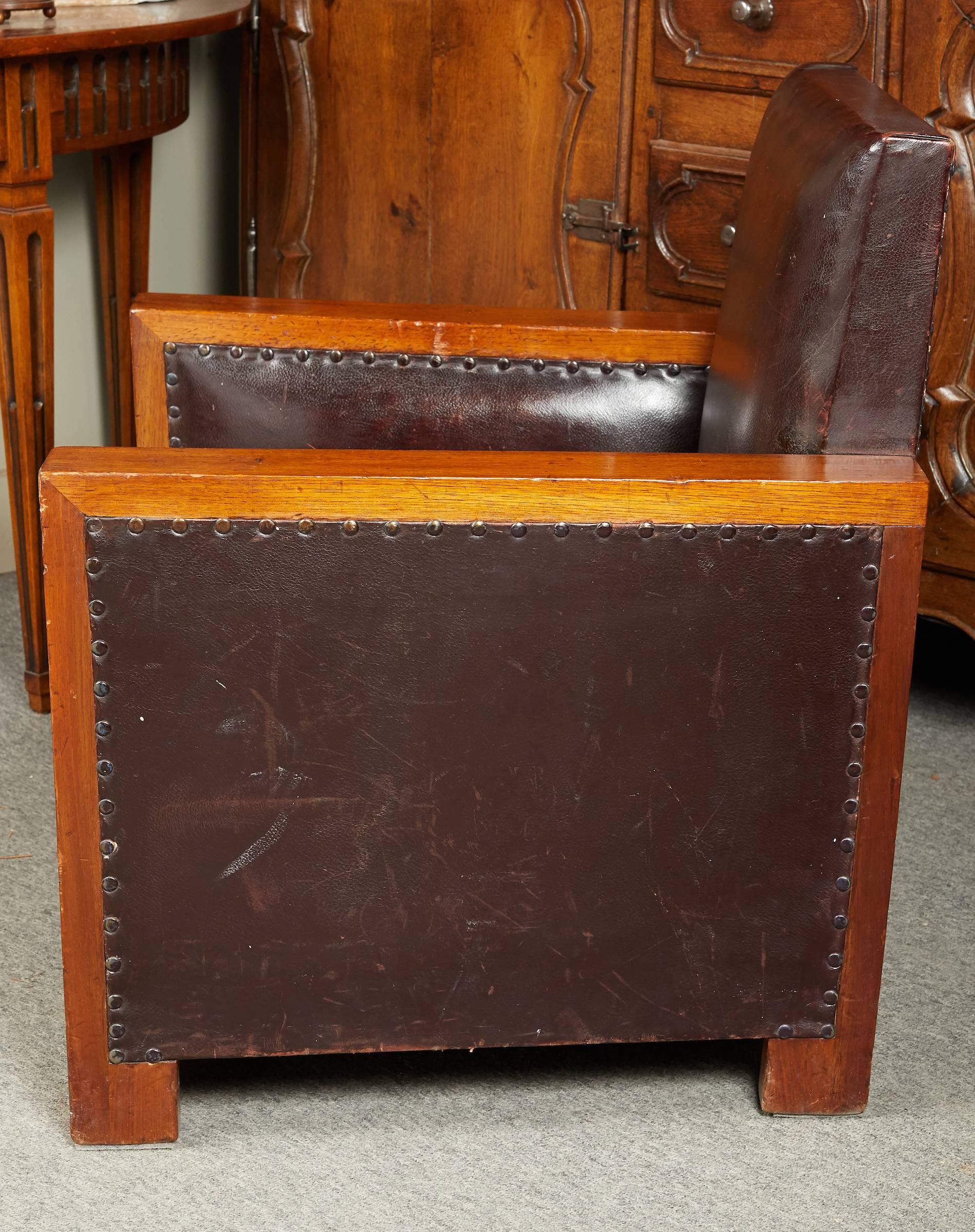 Graphic French Art Deco walnut and leather club chair with studded leather.
