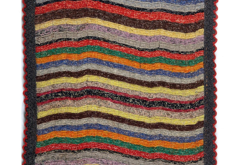 Late 19th or early 20th century Shaker textile with colorful and graphic horizontal bands and scalloped border. Ohio/Pennsylvania origin. Professionally mounted to a frame.