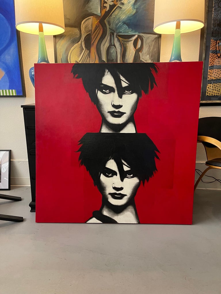 A stunning graphic mixed media on canvas with two portrait busts in red black and white. It is signed and dated on the back 2004. We cannot make out the name of the artist. The image seems comprised of a collage of photo images painted over. It is