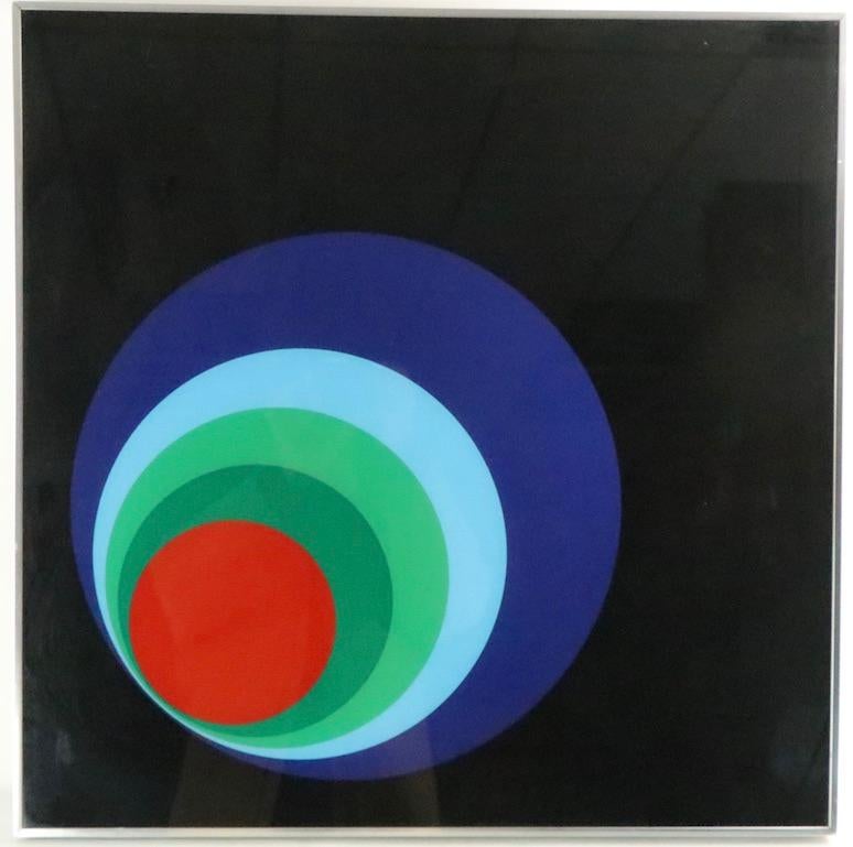 Extremely cool graphic wall hanging by Turner Manufacturing, in excellent, original condition. Stunning display of solid colors depicting concentric rings, on black ground, framed in aluminum frame.