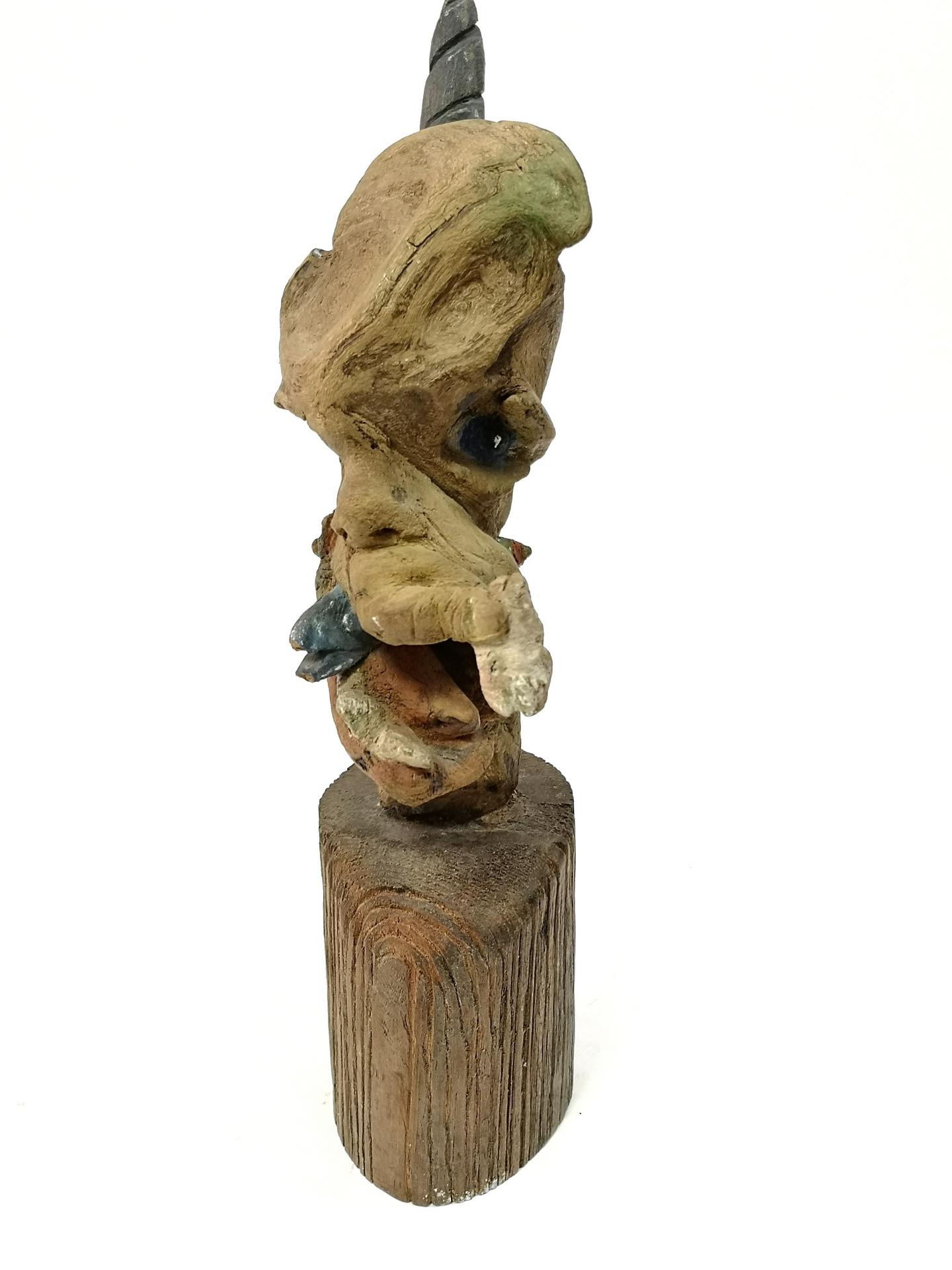 Graphic, organic carved head sculpture. Uknown artist.