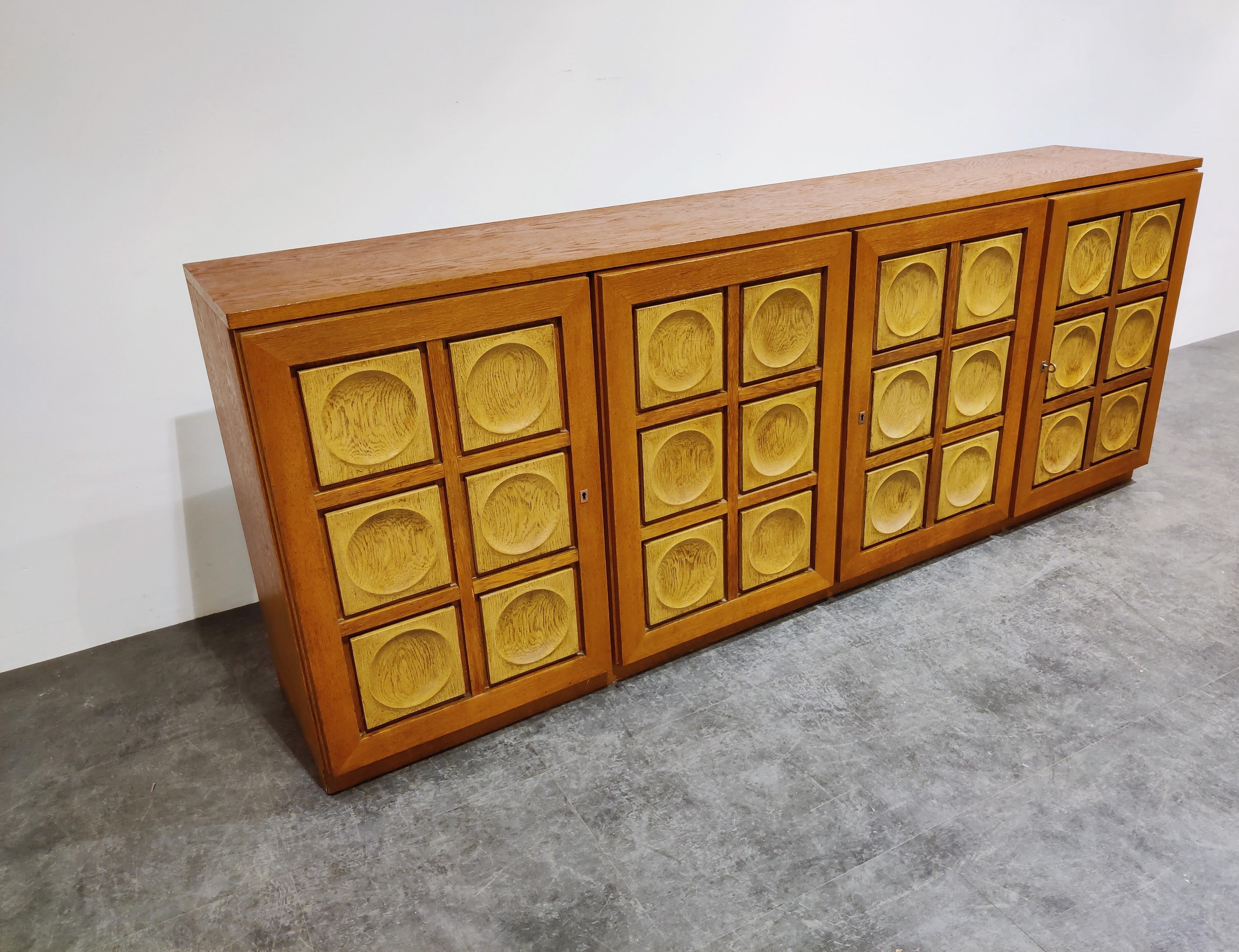 Request a shipping quote, the shown rates are automatically generated by 1stdibs

Brown Brutalist two tone oak credenza with 4 graphical doors.

Beautiful timeless design and a real eye catcher for your living room.

This credenza provides