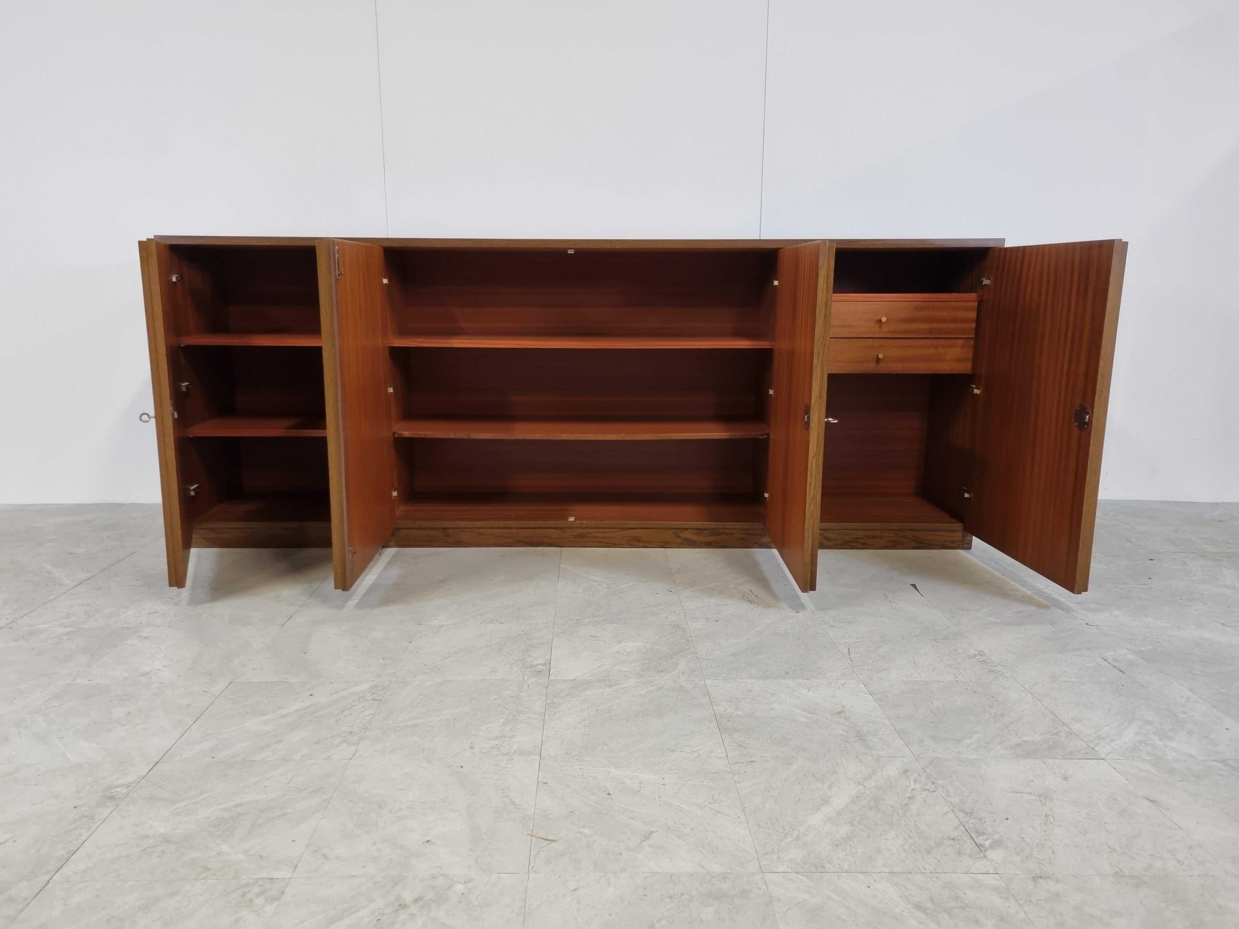 Brown Brutalist two tone oak credenza with 4 graphical doors.

Beautiful timeless design and a real eye catcher for your living room.

This credenza provides plenty of storage space with two integrated drawers.

Good condition

1970s -
