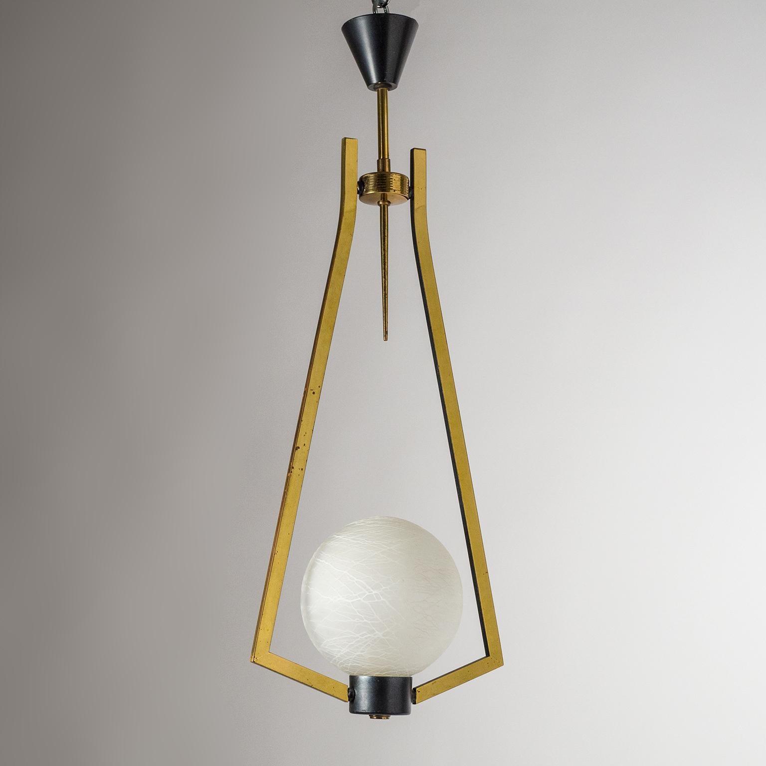 Graphical French modernist brass and glass pendant, circa 1960. Geometric polished brass hardware (partially patinated/lacquered in a dark metallic hue) with a satin glass globe which is covered with a random mesh of fine white enamel, akin to